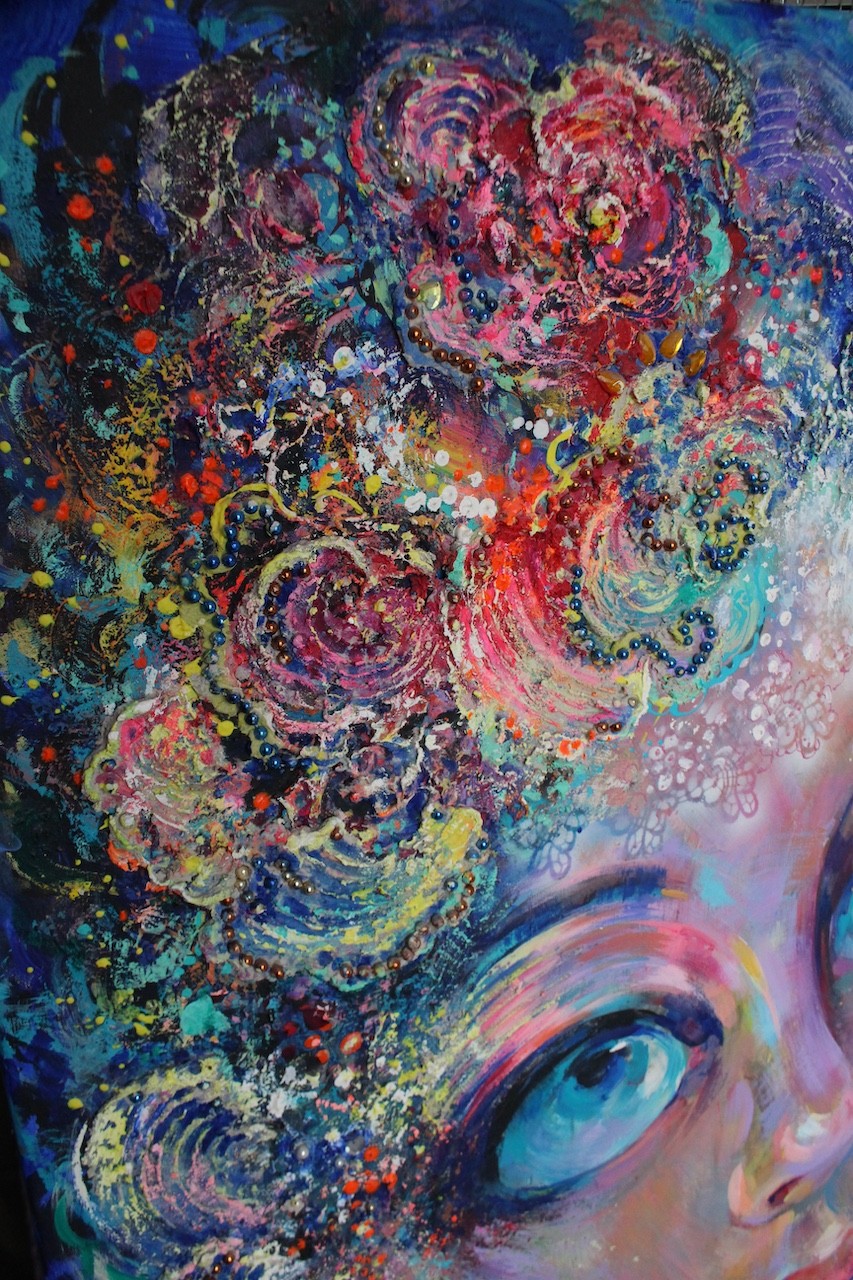 A surreal portrait of a figure with flower-like hair against a dreamy, textured background.