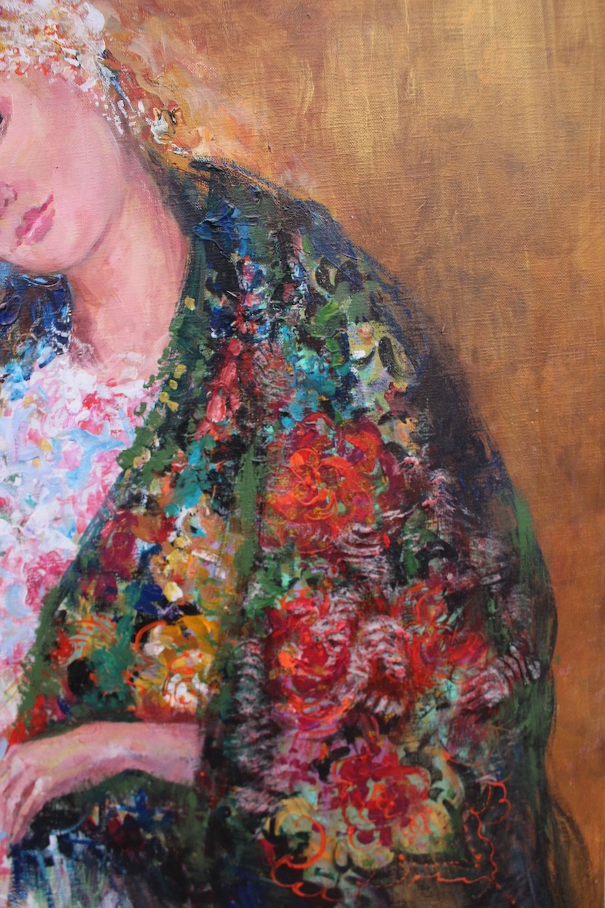 Three figures in flowing, floral-patterned gowns pose closely together against a warm background.