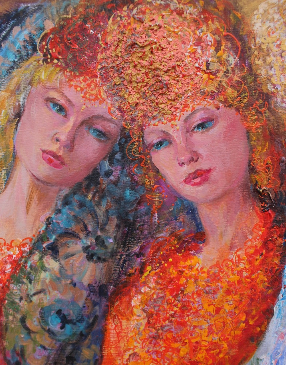 Three figures in flowing, floral-patterned gowns pose closely together against a warm background.