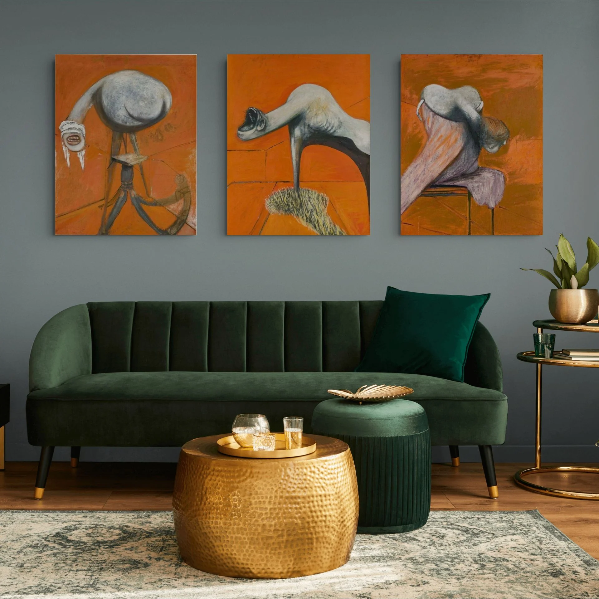 A triptych of surreal, fleshy figures against a vibrant orange background.