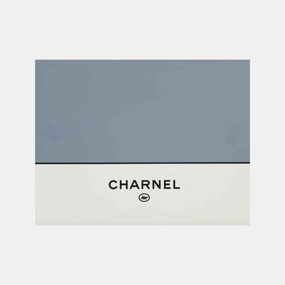 A minimalist print featuring stacked orange text on a blue background.
