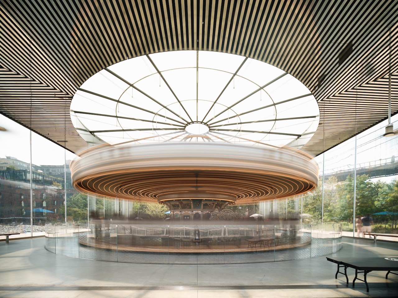 A circular carousel in the middle of a large building.