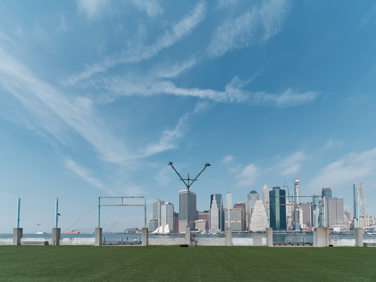 A view of a city skyline from a grassy field.