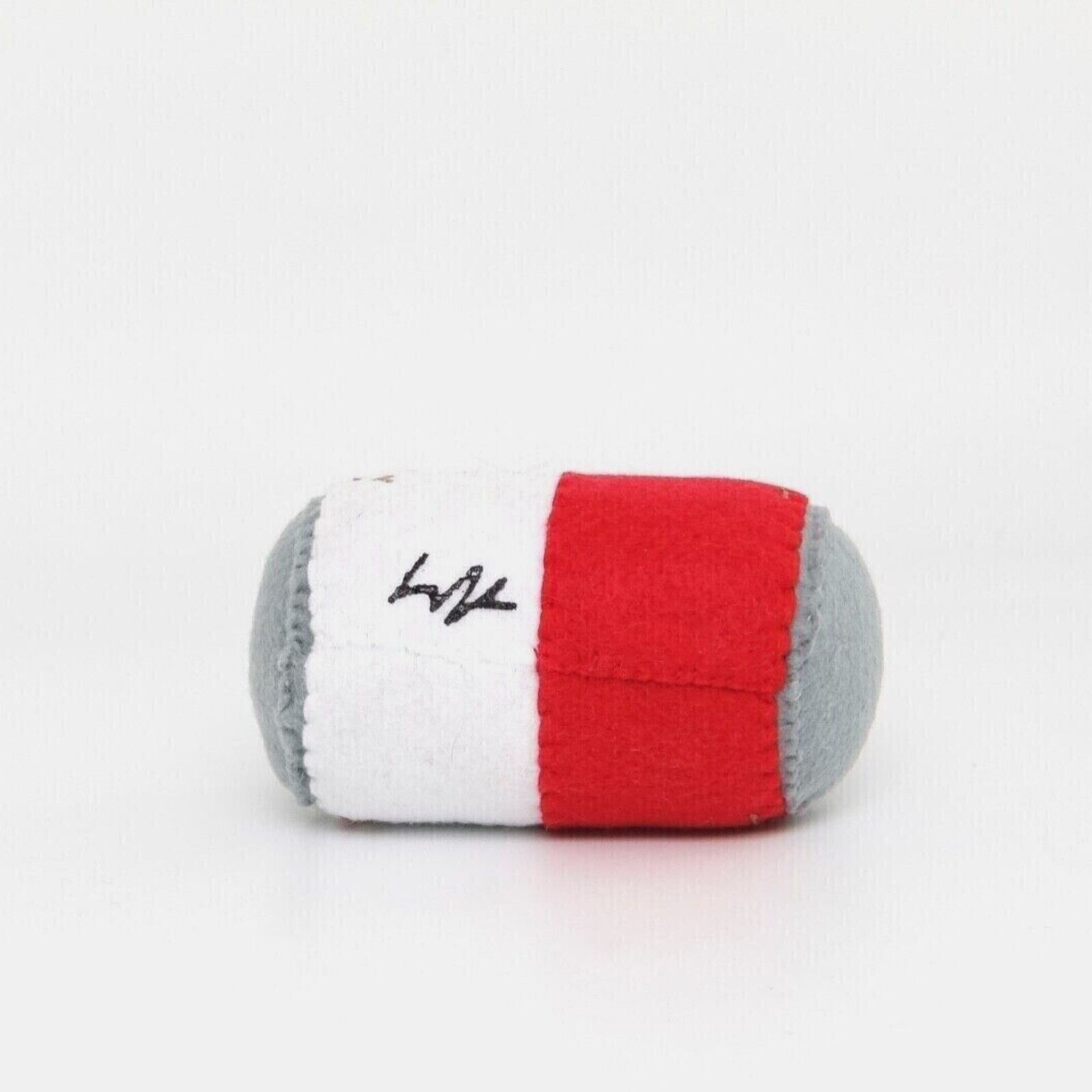 A stuffed toy of a can of soup with a cookie on it.