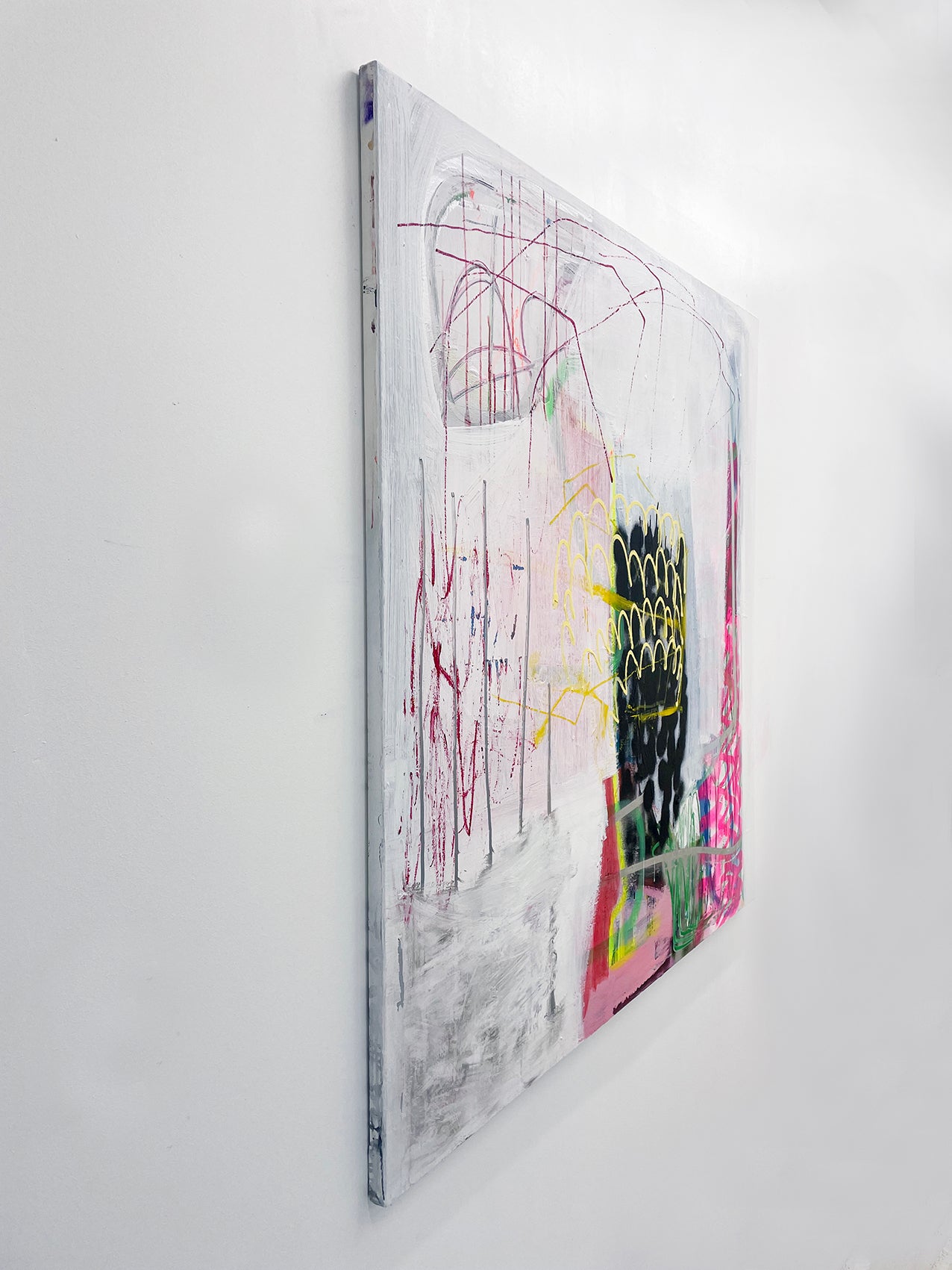 A painting on a white wall with a black and yellow design.