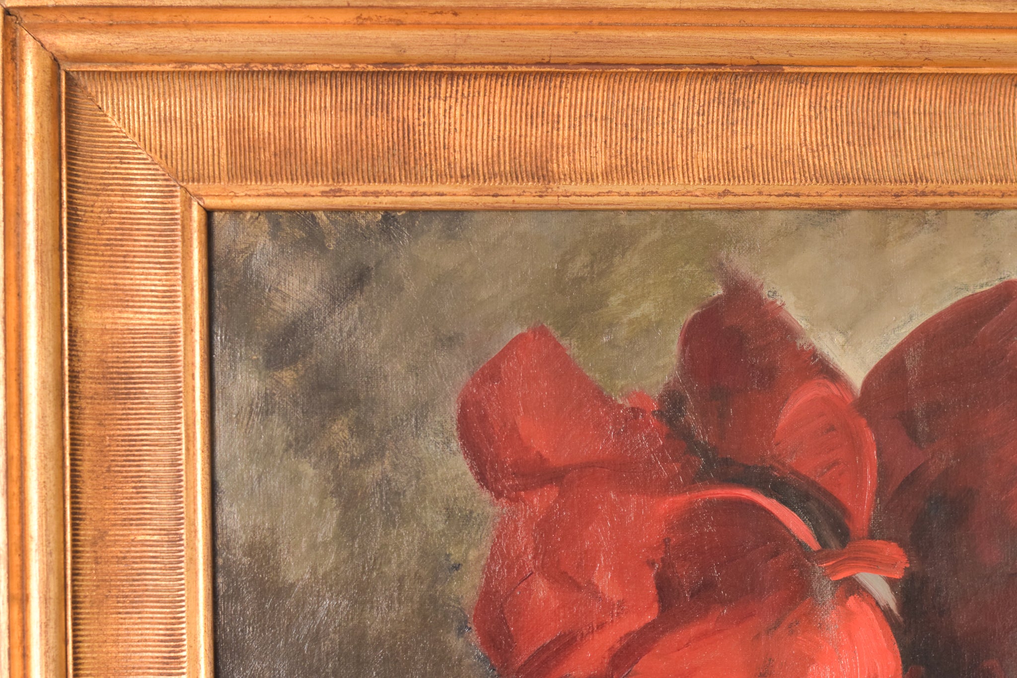 A painting of red flowers in a white vase on a table.