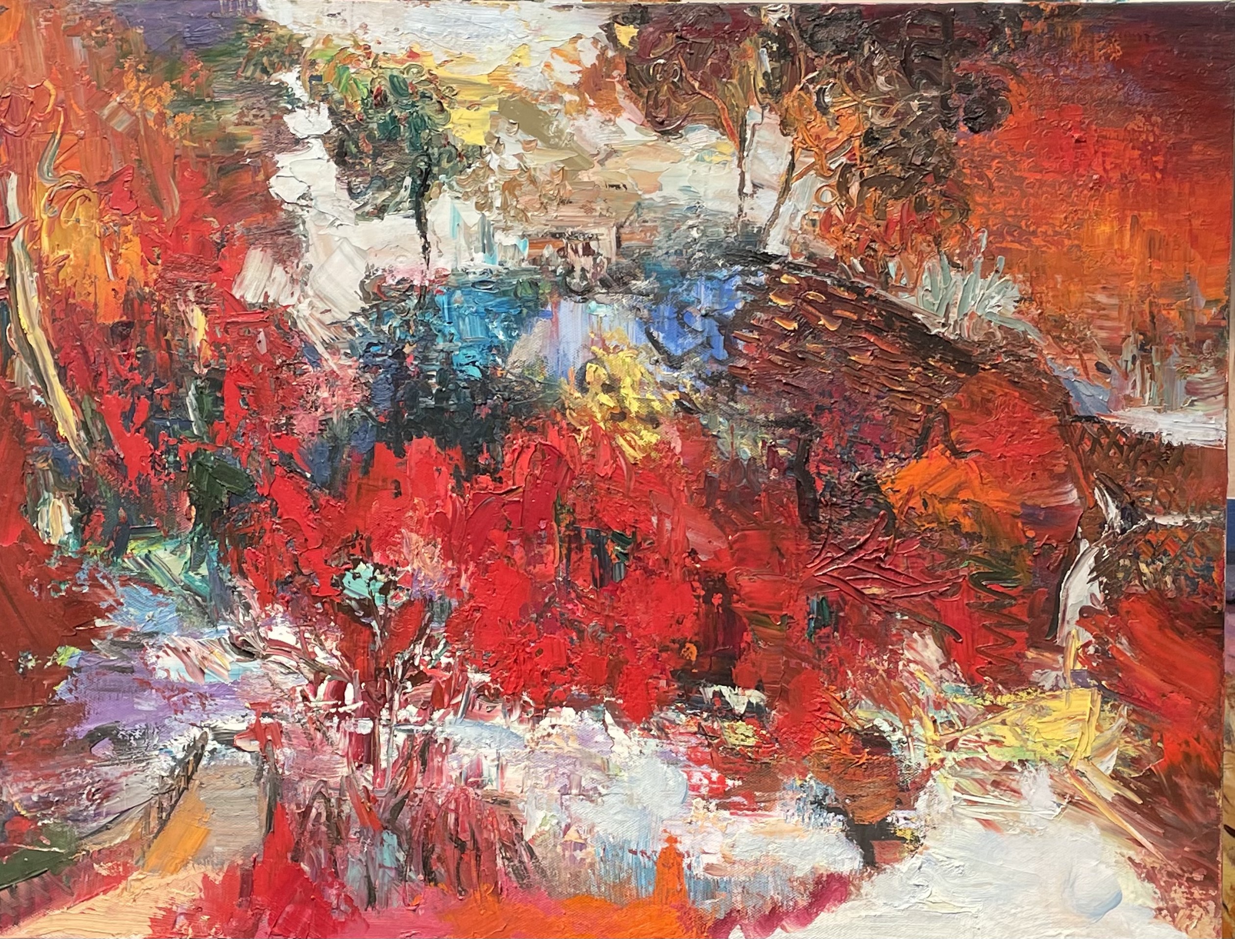 A vibrant, abstract landscape painting featuring bold reds and blues with thick impasto technique.