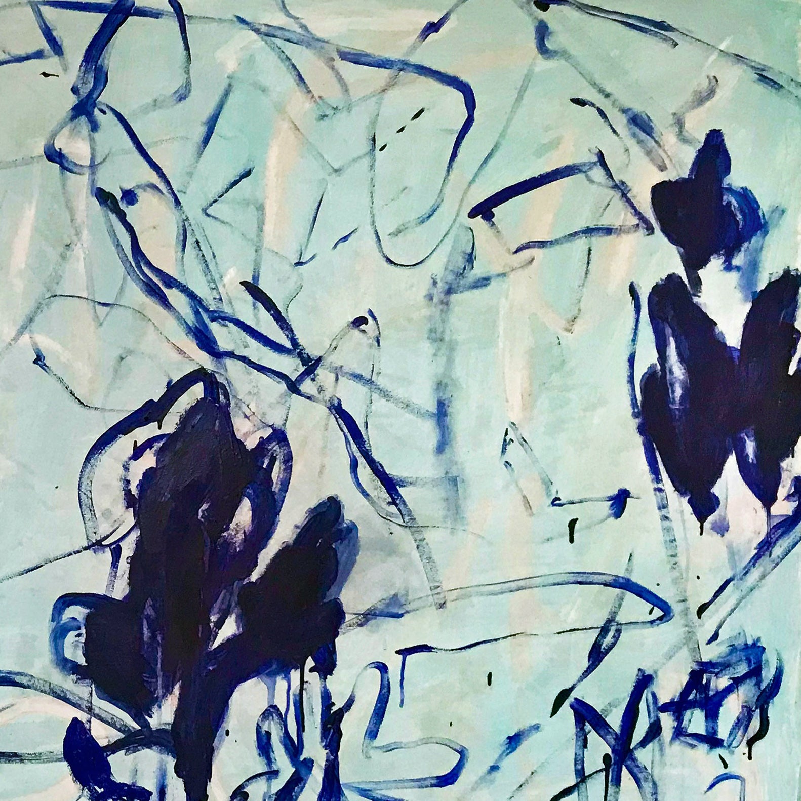 A blue and white painting on a white wall.