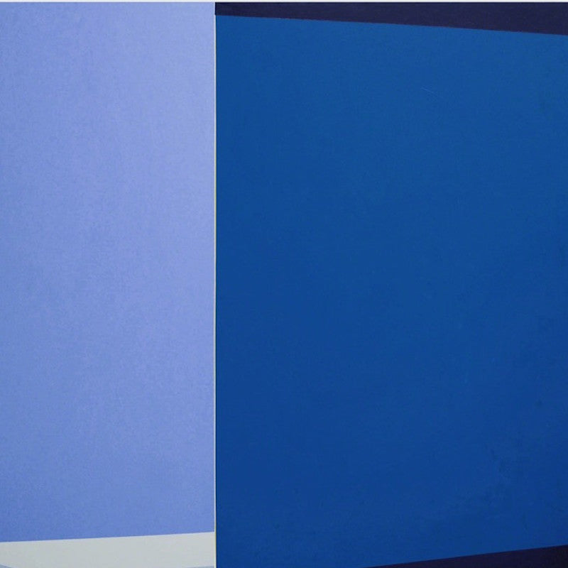 A blue and white painting on a white wall.