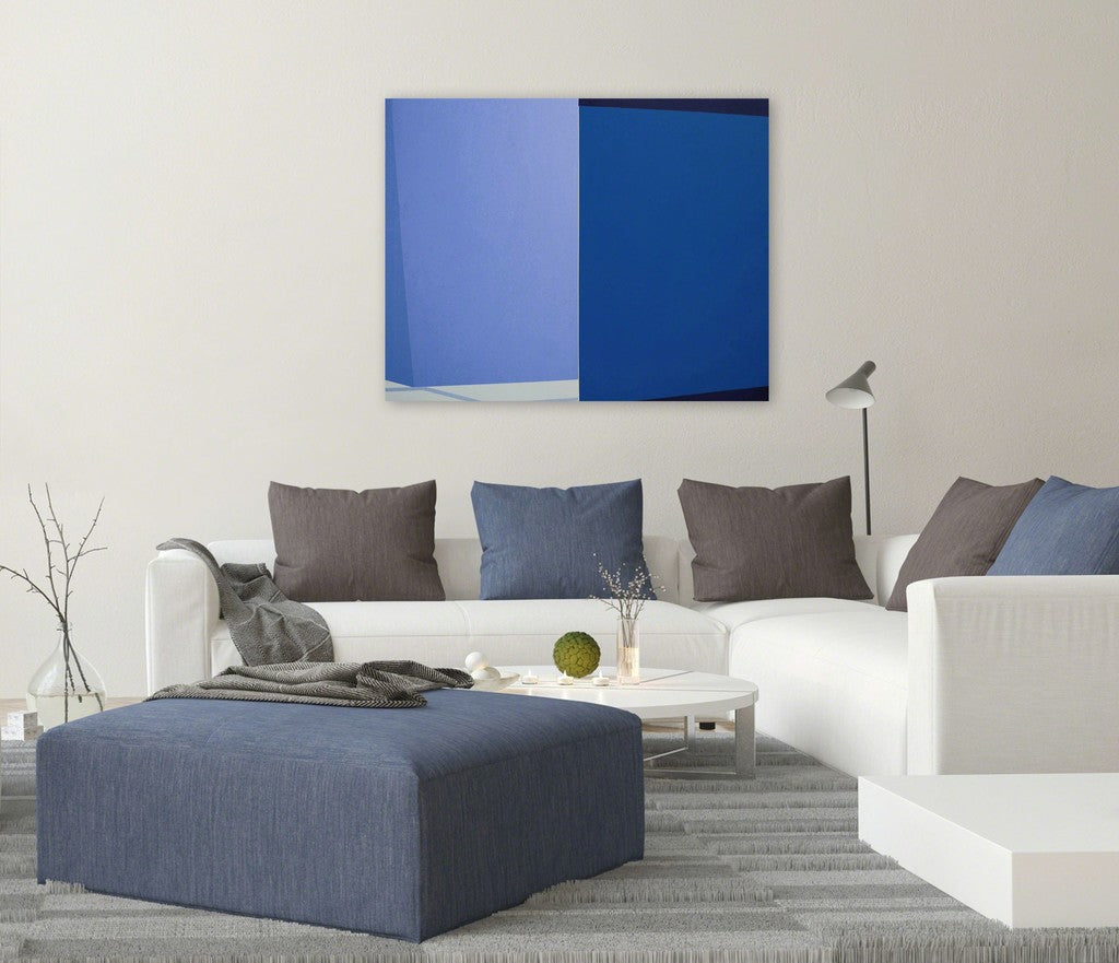 A blue and white painting on a white wall.