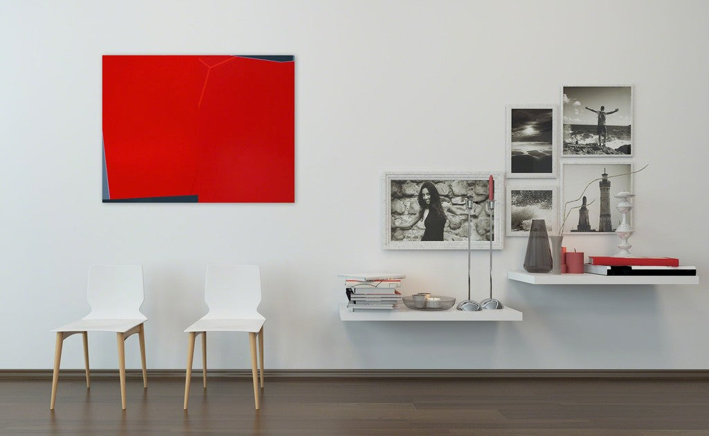 A red and black painting on a white wall.