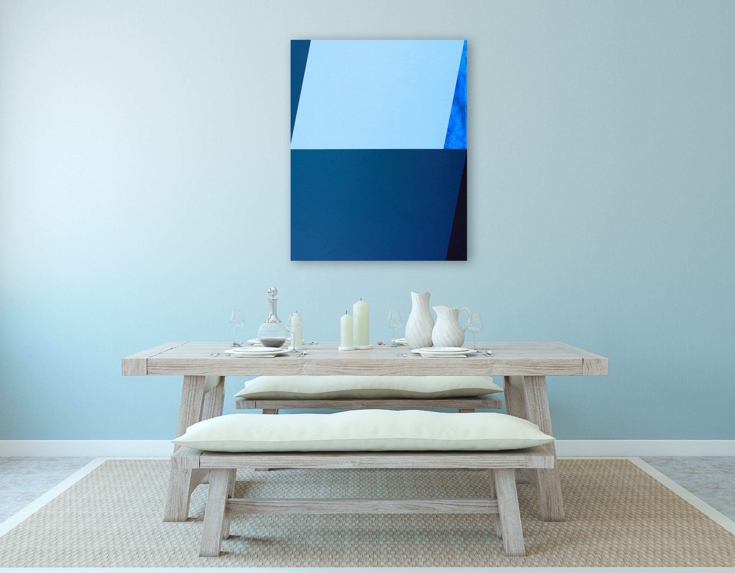 A blue and black painting on a white wall.