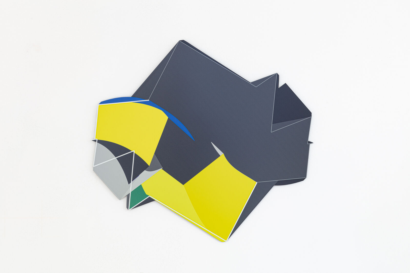 A yellow and blue piece of paper on a white surface.