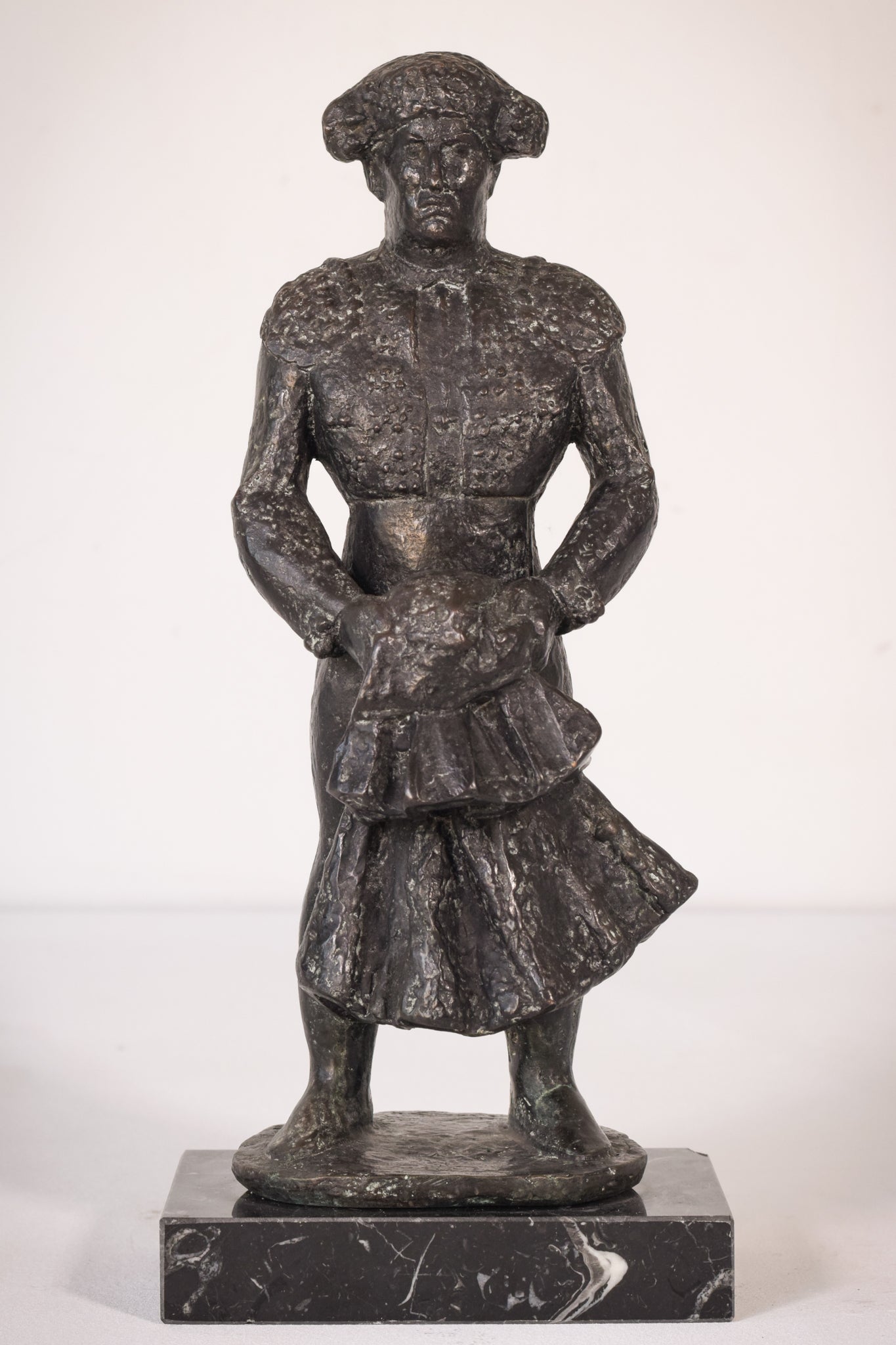 A bronze statue of a man holding a baby in his arms.