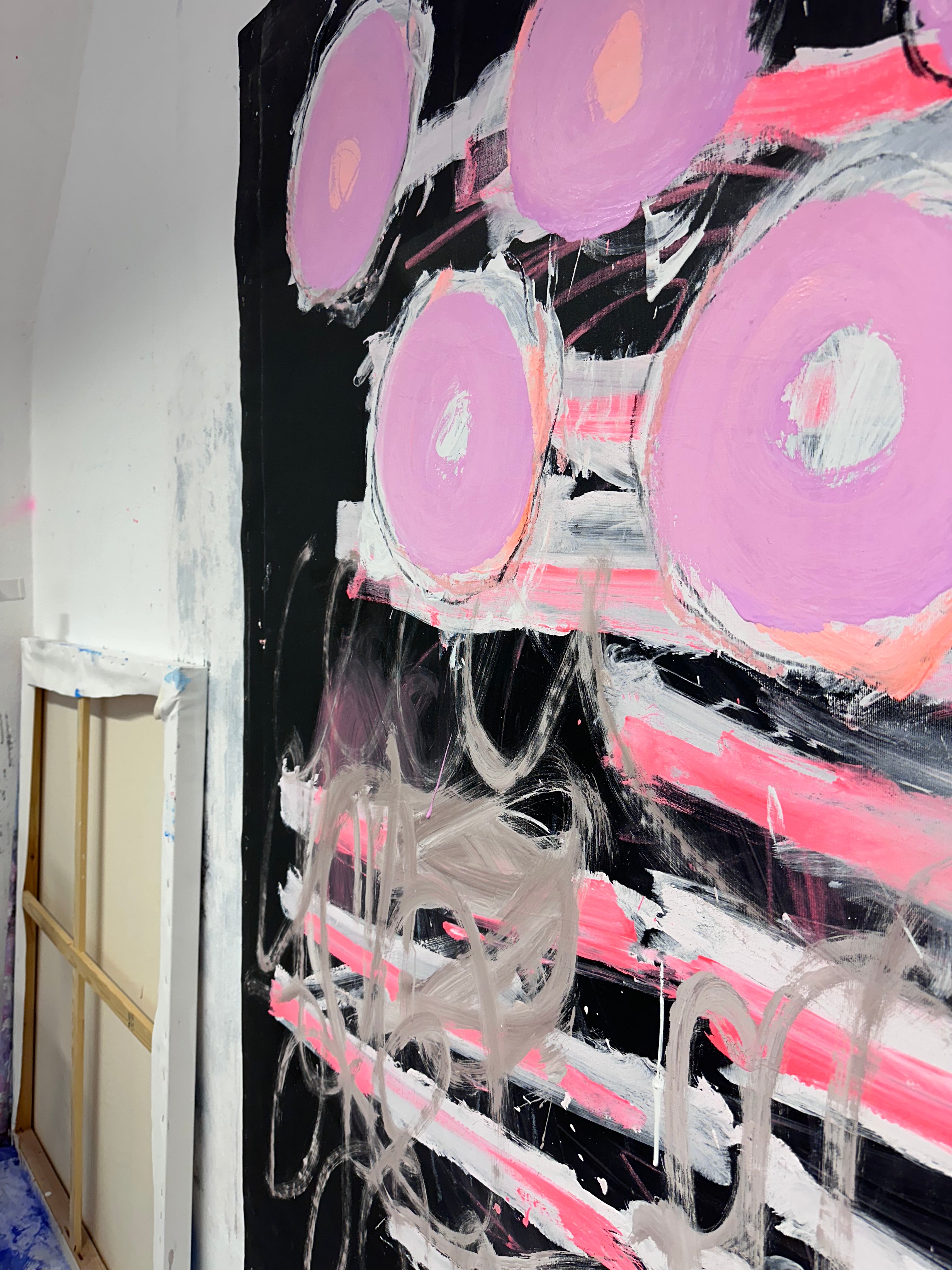 A painting with pink circles on a black background.