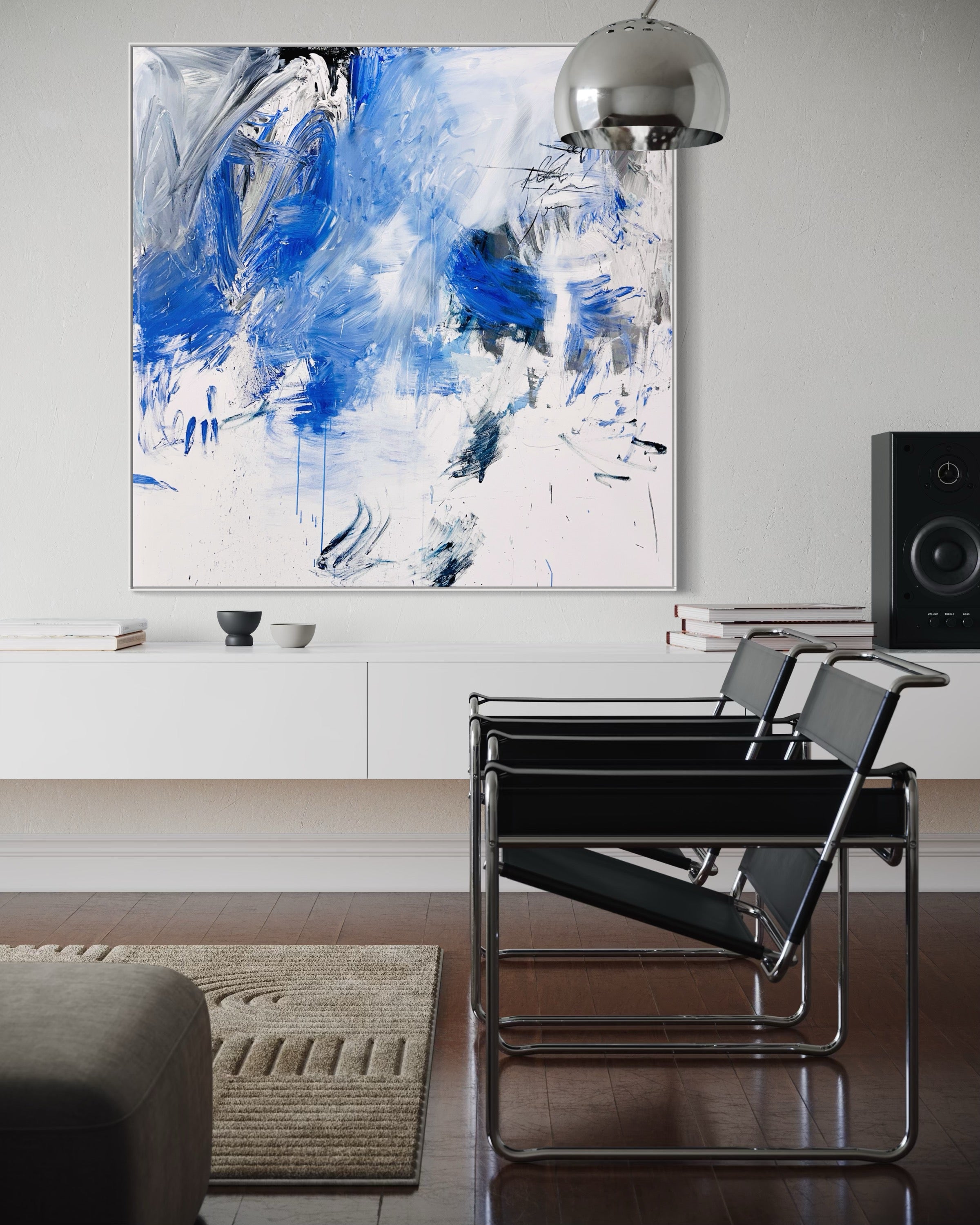 A blue and white abstract painting on a white wall.