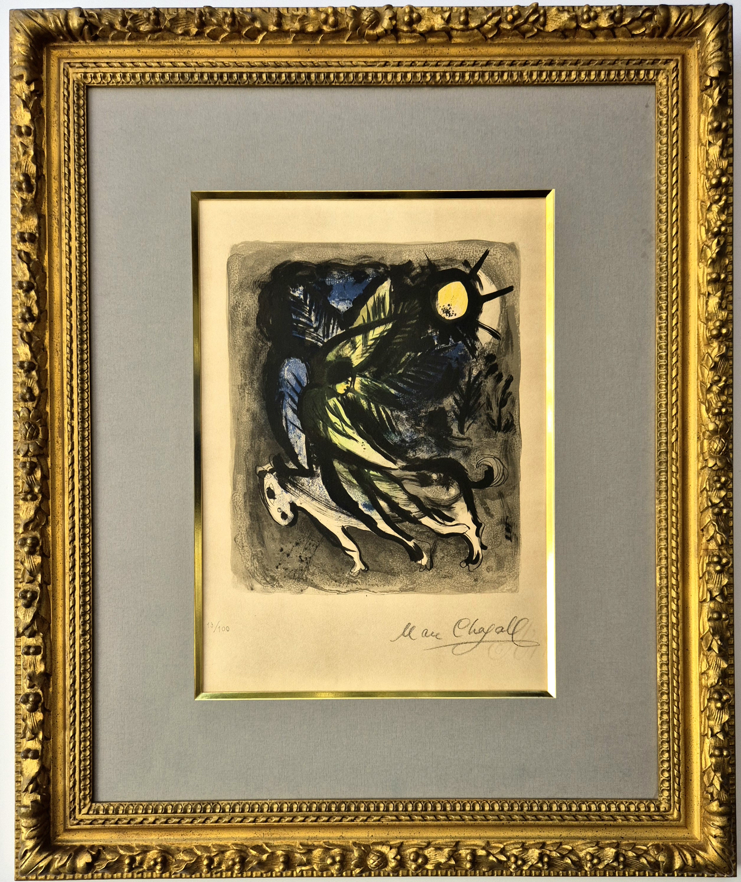 A framed print of a painting in a gold frame.