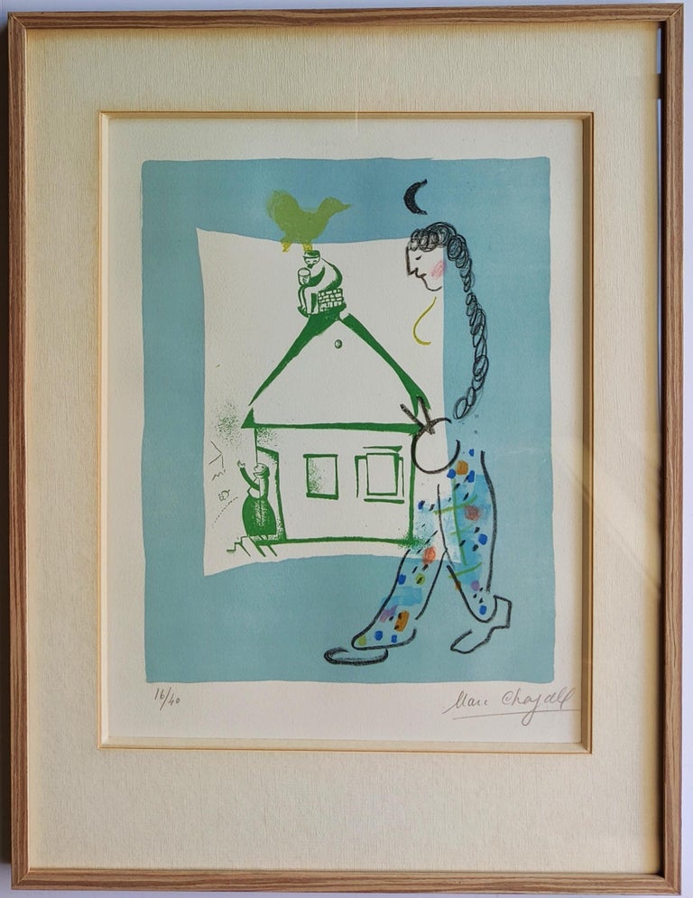 A framed print of a woman walking past a house.
