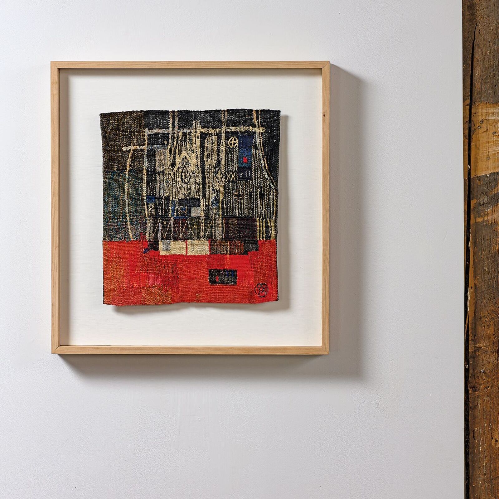 A picture hanging on a wall next to a wooden wall.