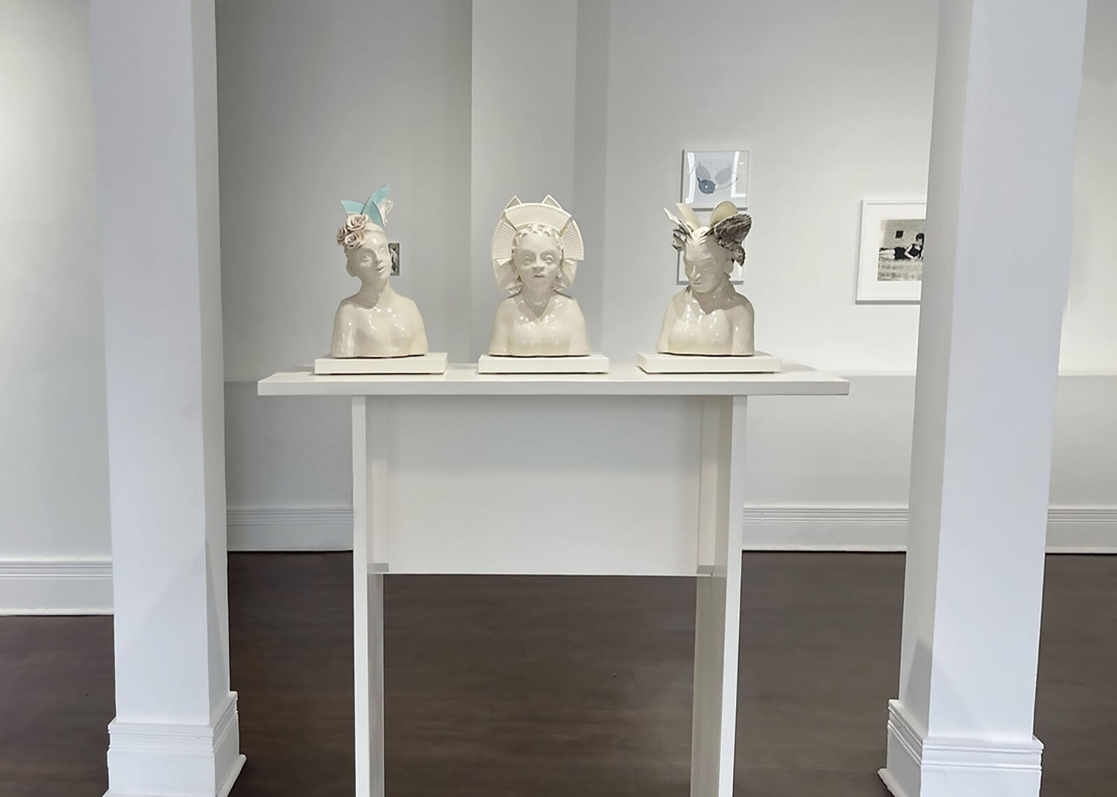 A ceramic bust adorned with broken porcelain fragments forming a headdress.