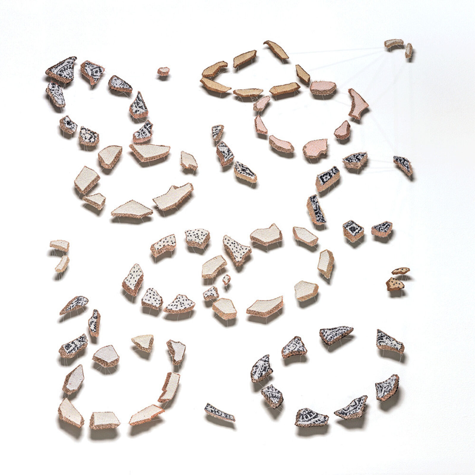 A scattered arrangement of ceramic shards on a white surface.