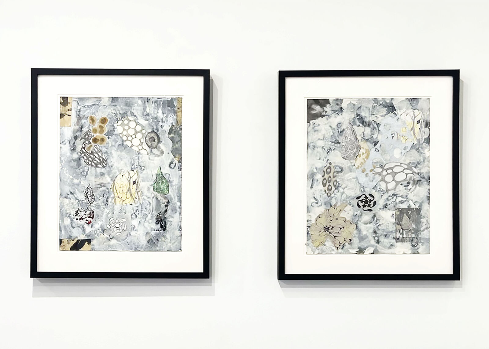 A textured mixed-media collage featuring organic shapes, abstract patterns, and splattered paint on a mottled grey background.