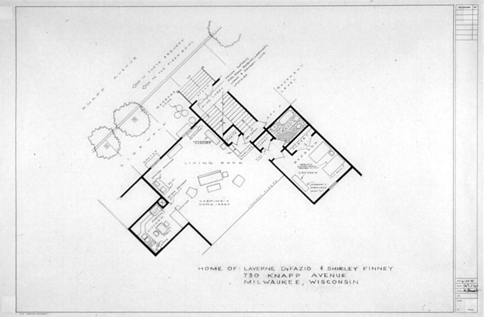 A black-and-white architectural floor plan of a mid-century modern house with an L-shaped layout and surrounding landscape.