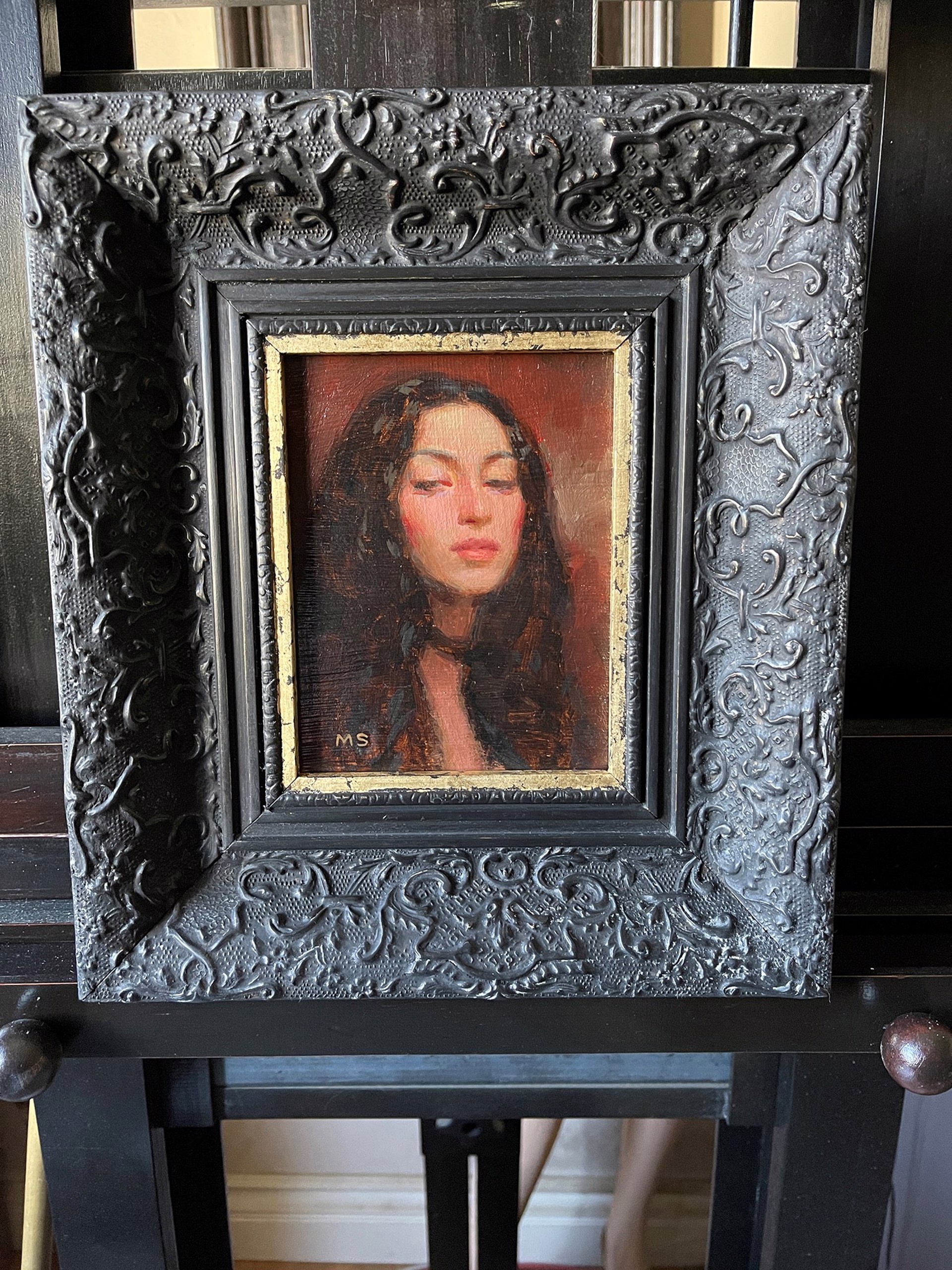 A painting of a woman with her eyes closed. 