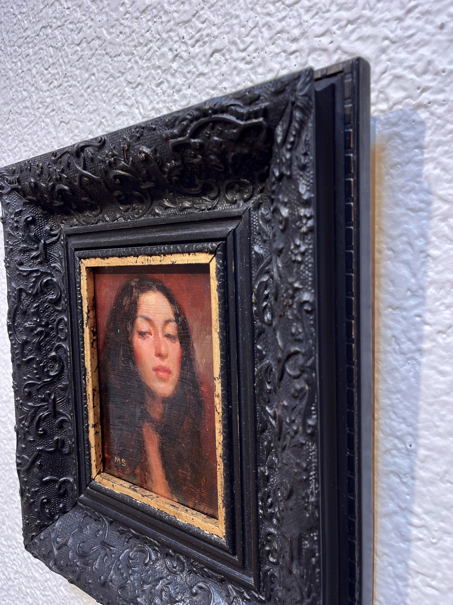 A painting of a woman with her eyes closed. 
