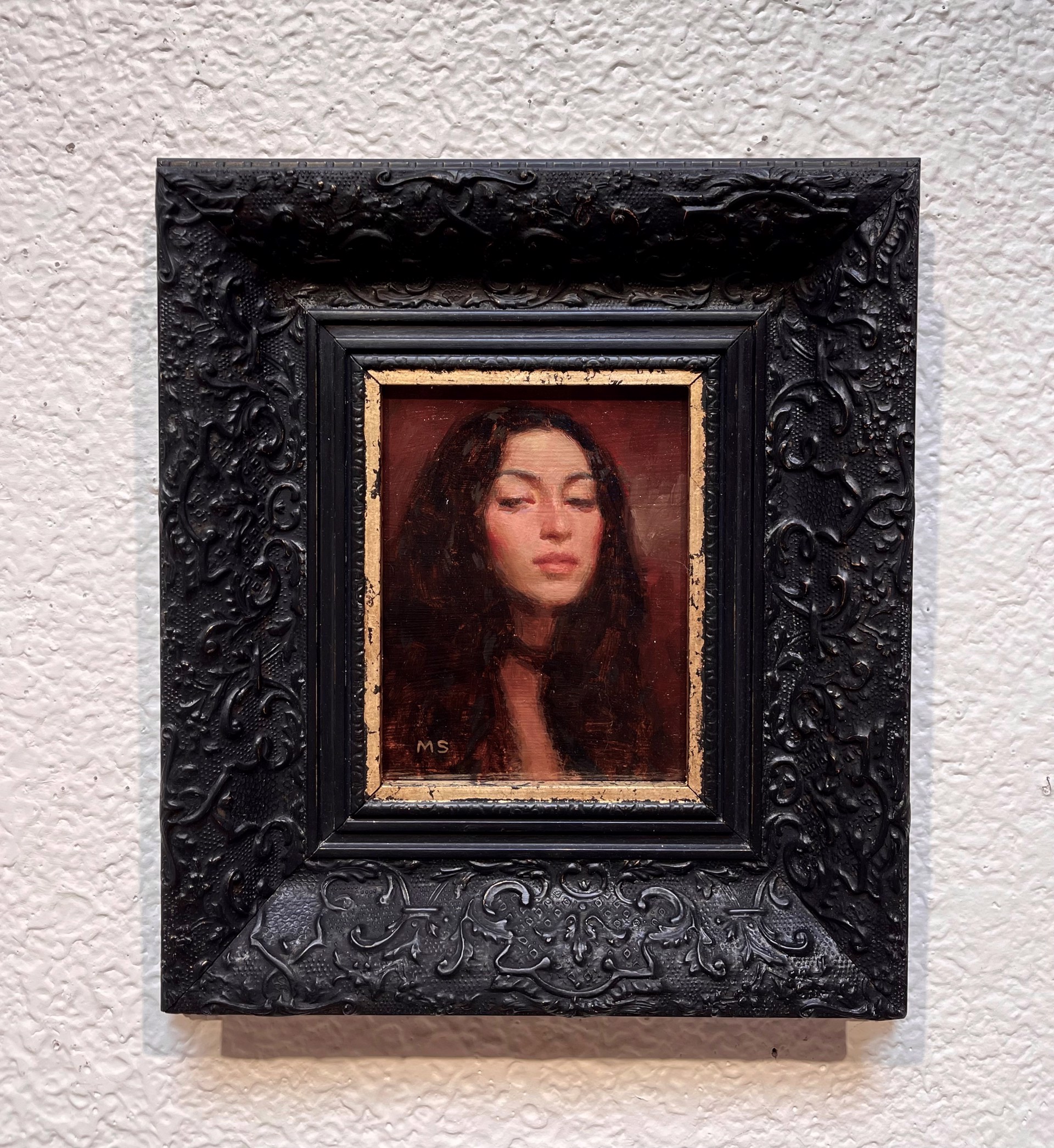 A painting of a woman with her eyes closed. 