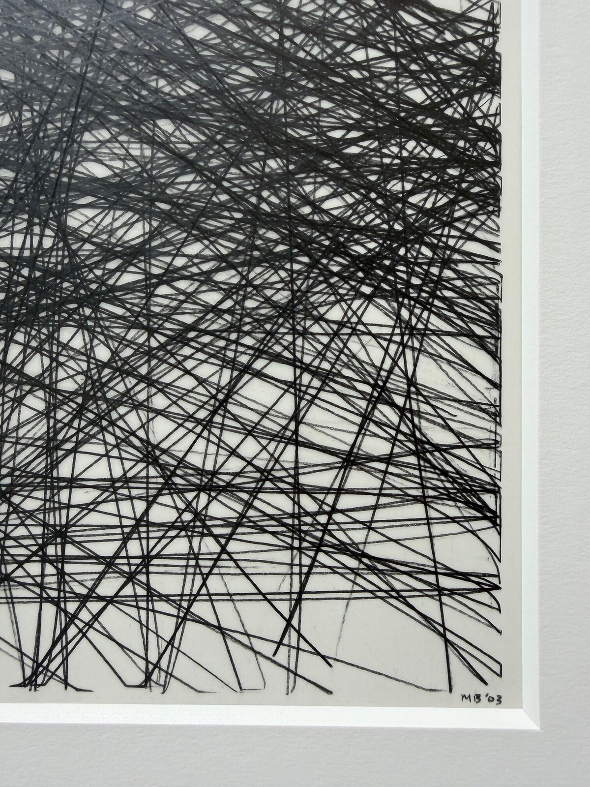 A monochromatic abstract drawing featuring a dense web of intersecting black lines on white paper, framed in black.