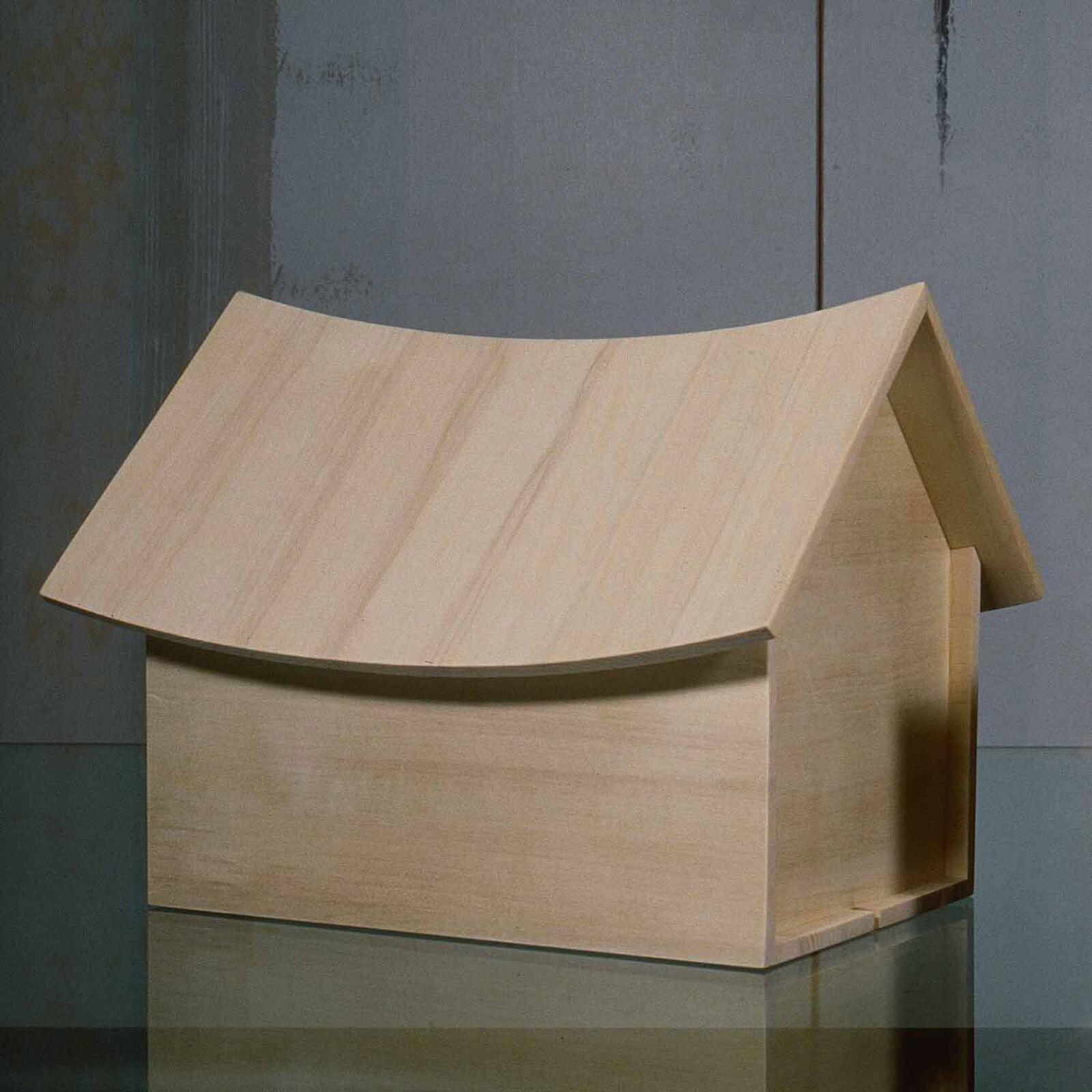 A small wooden house sitting on top of a table.