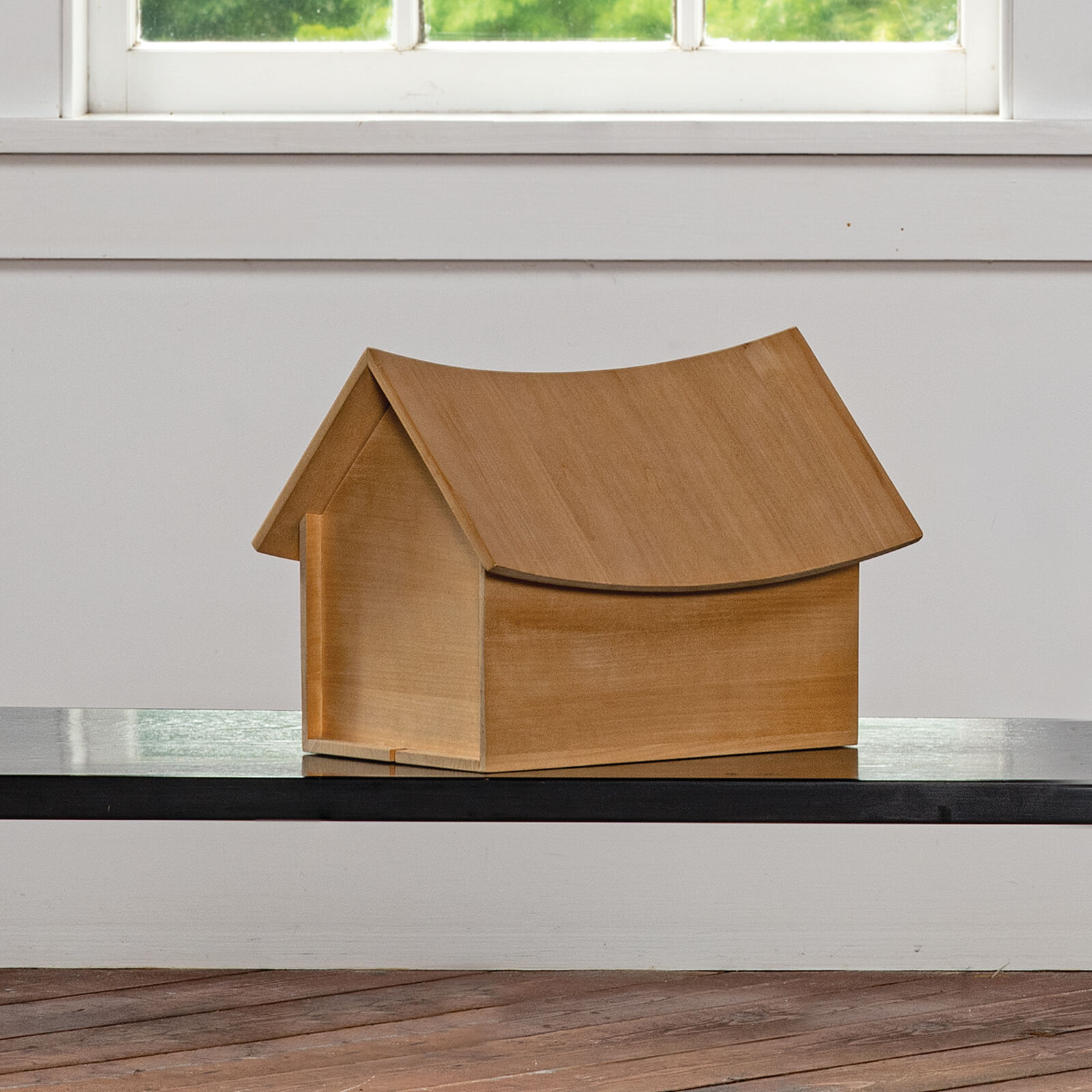 A small wooden house sitting on top of a table.