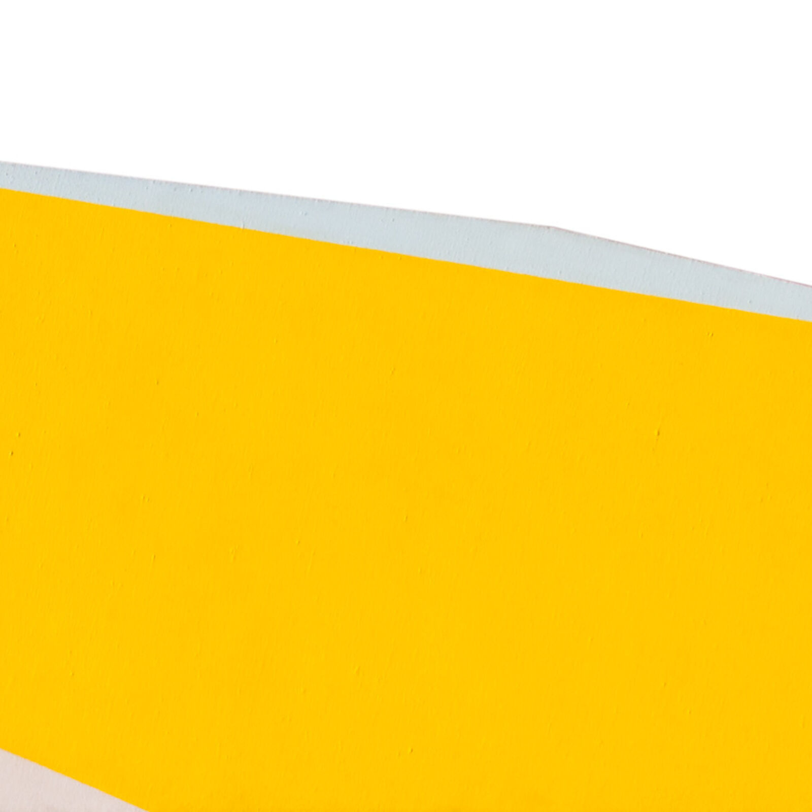 a yellow and white paper airplane on a white background