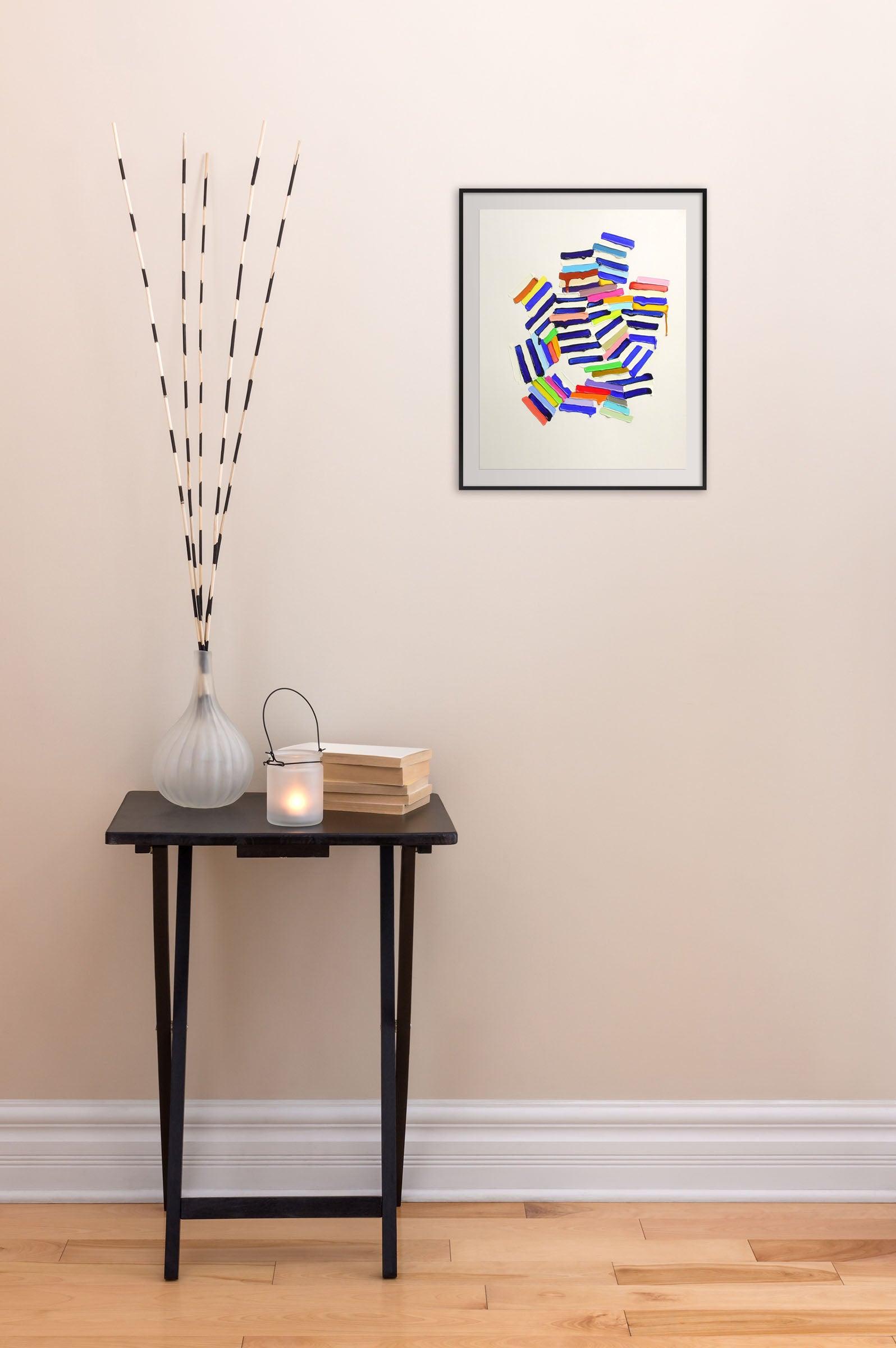 A painting of a pile of colorful paint on a white surface.