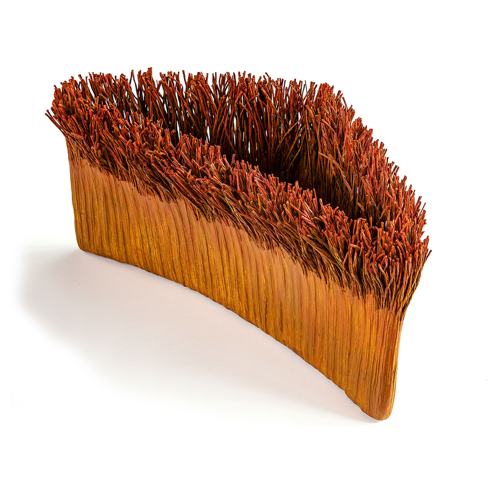 A sculptural piece resembling a miniature grassy mound with a smooth, curved base.