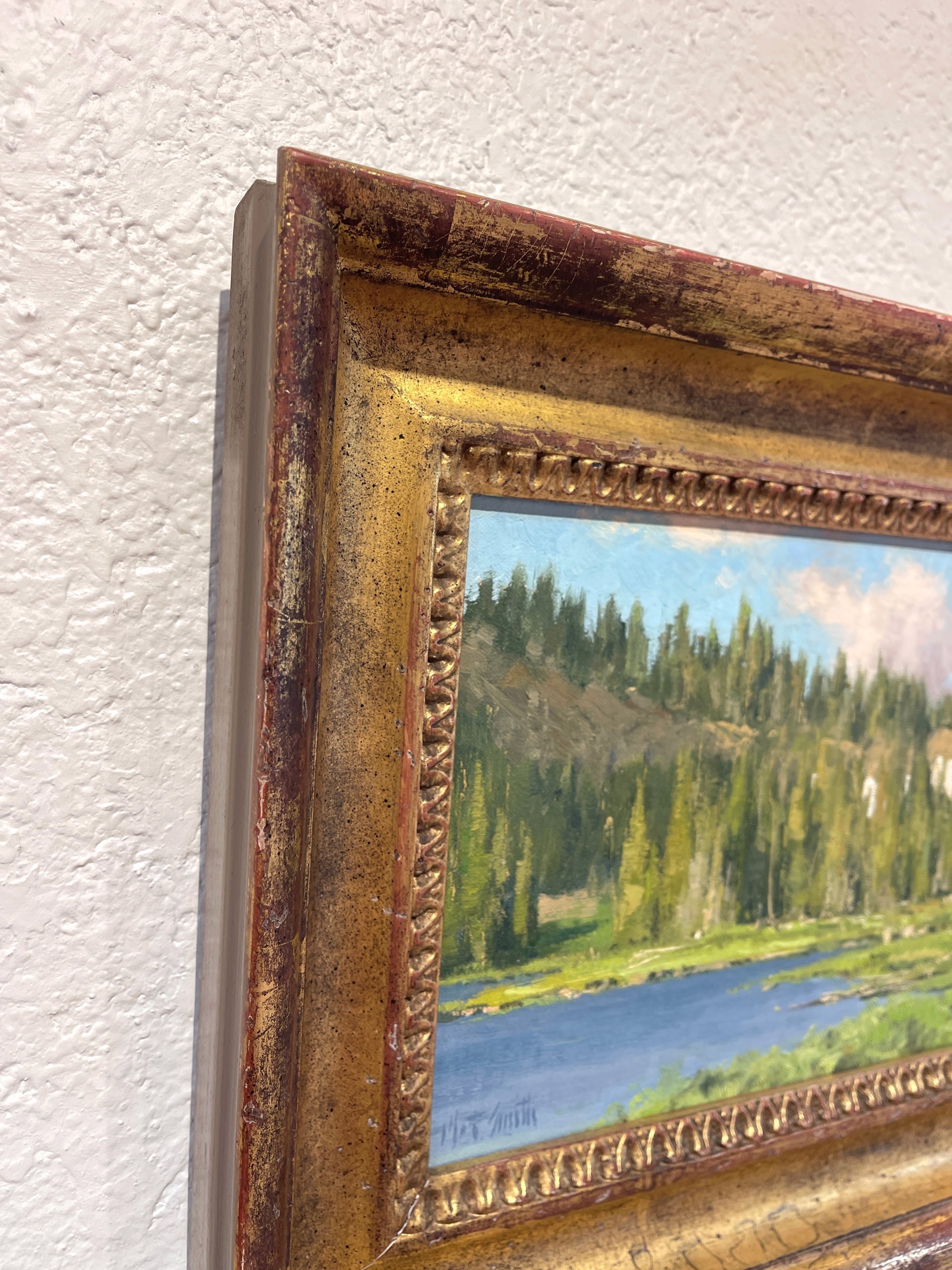 A painting of a lake in the middle of a forest.