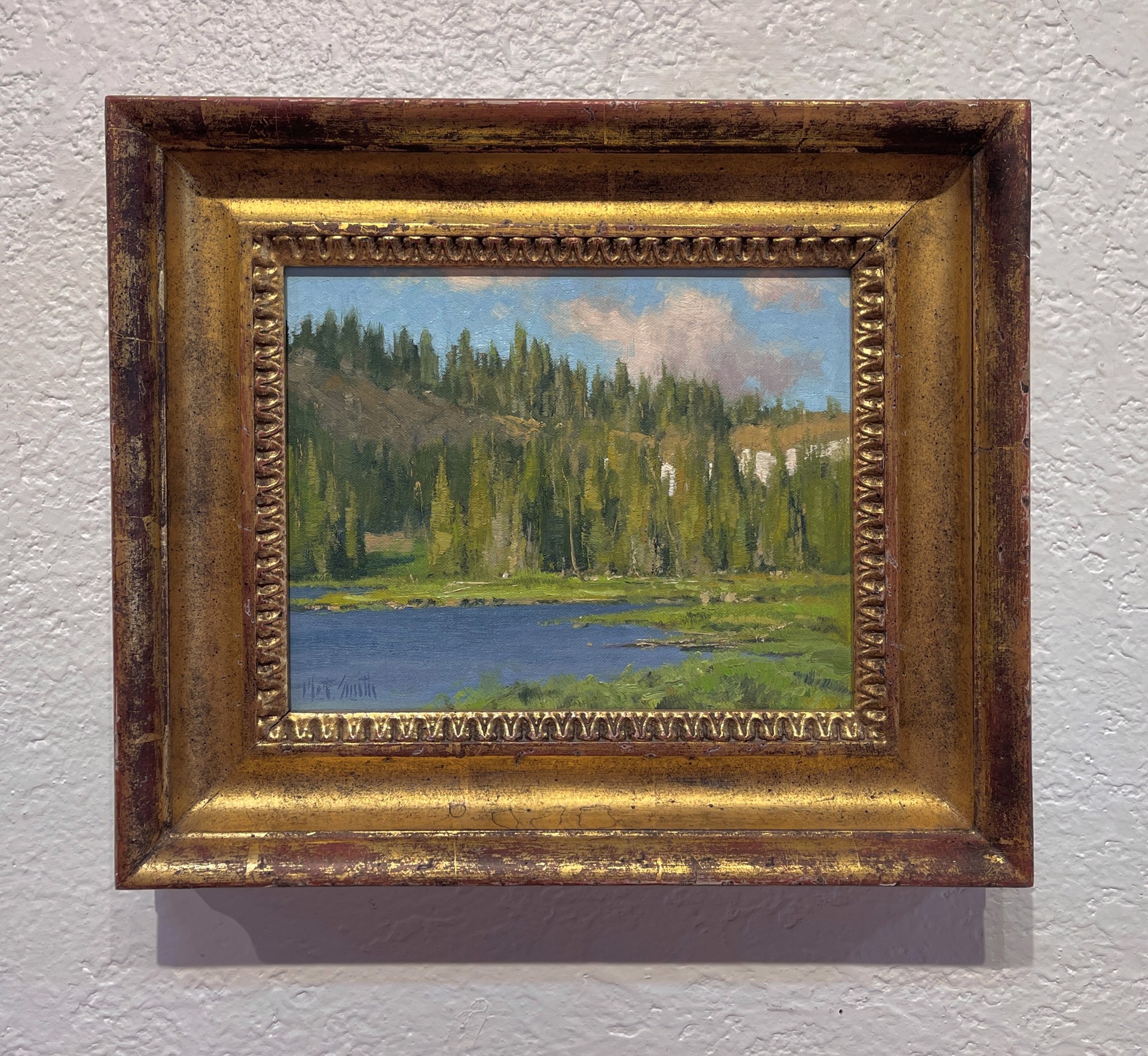 A painting of a lake in the middle of a forest.