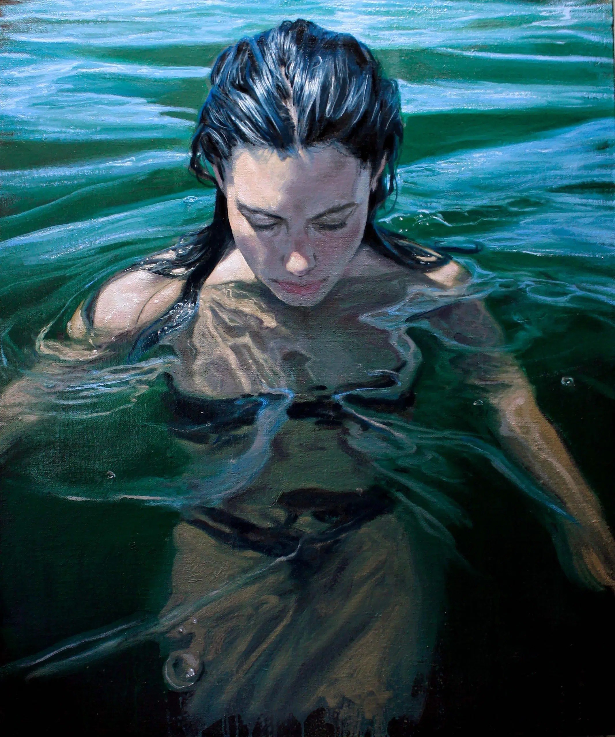 A close-up portrait of a person submerged in water, eyes closed, with light filtering through the surface above.