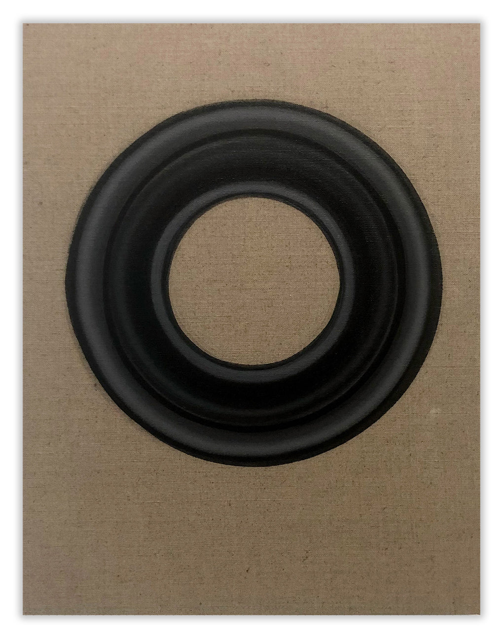 A black ring on a brown cardboard box. 