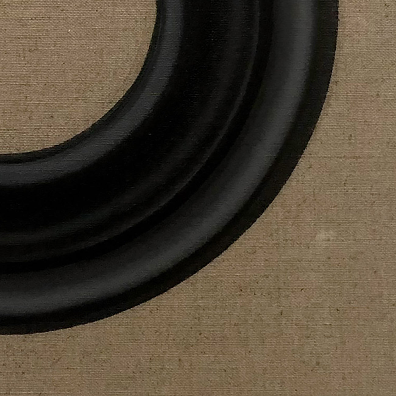 A black ring on a brown cardboard box. 