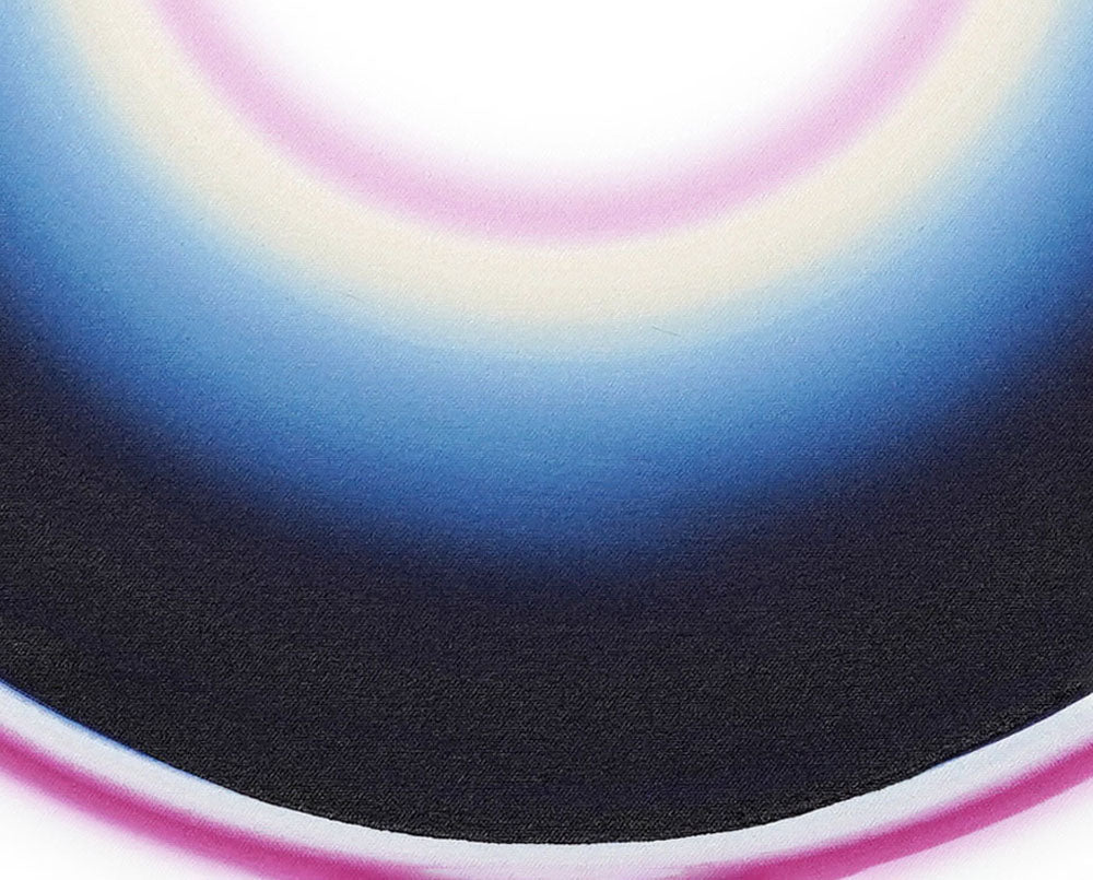 A black circle with a pink and blue circle in the middle.