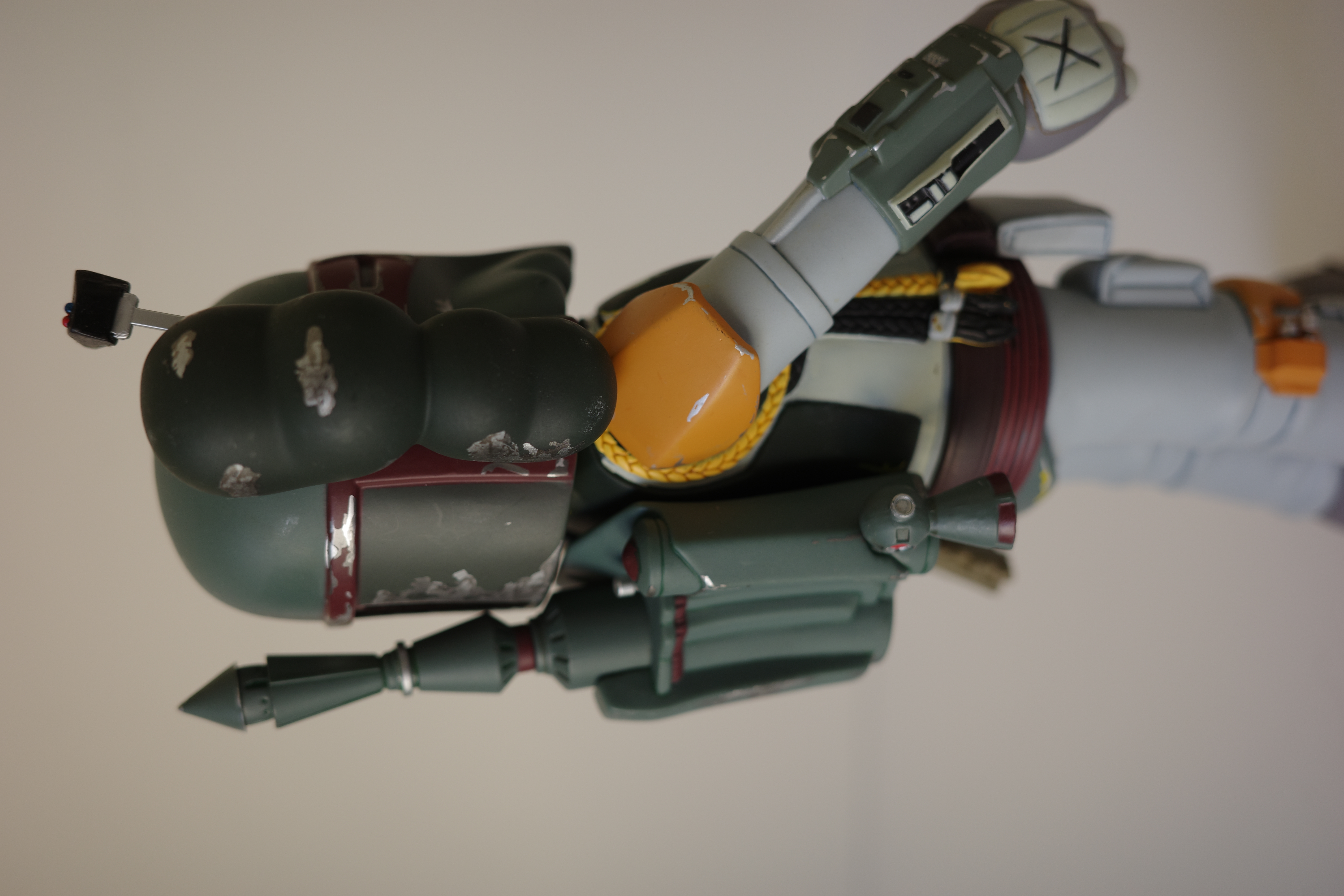 A close up of a toy figure of a boba fett.