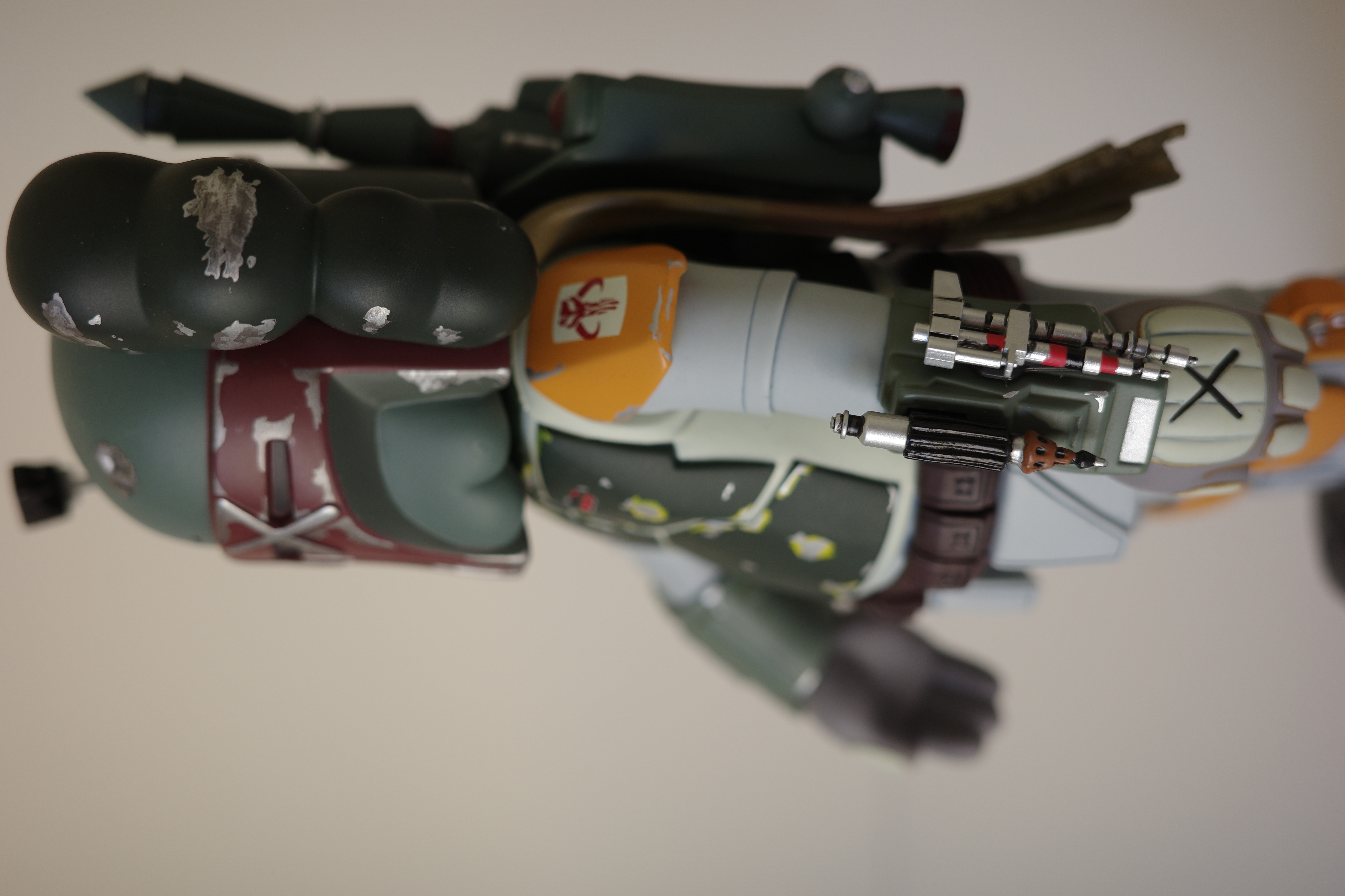 A close up of a toy figure of a boba fett.