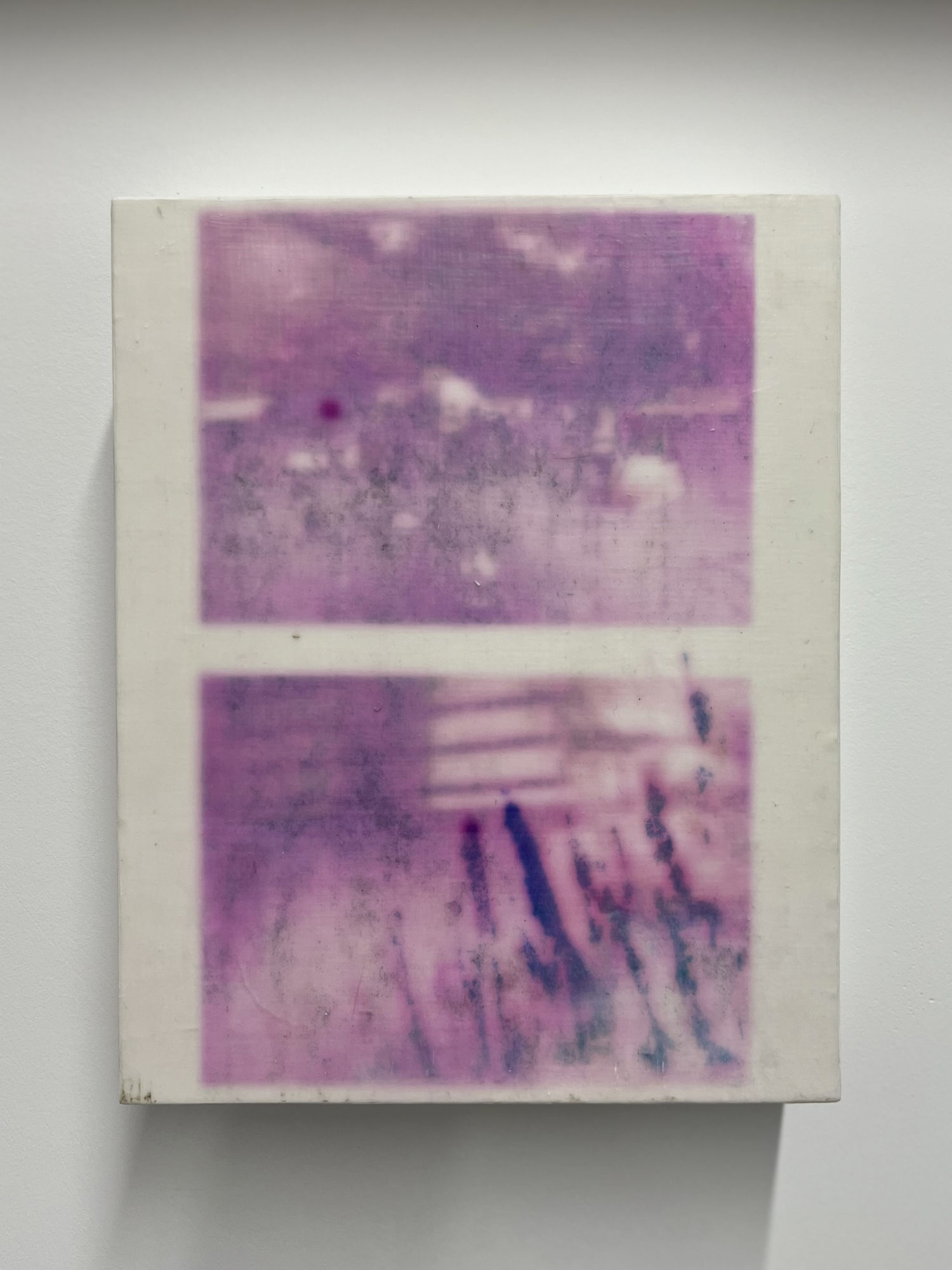 A picture of a purple and white painting on a wall.