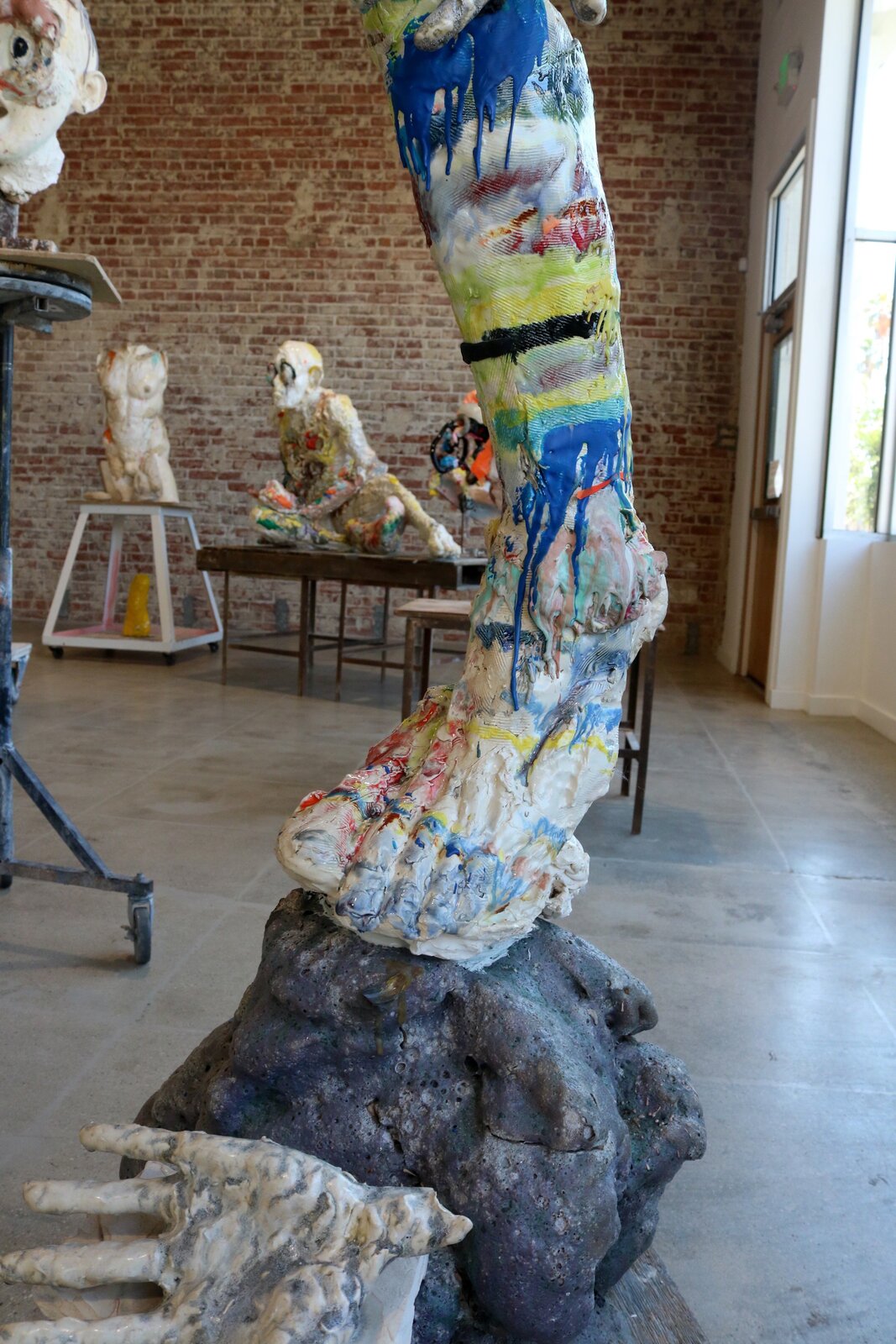 Artwork by Meghan Smythe, figures flanking a sacred tree, Made of Ceramic, Glaze, plasticine, epoxy, rubber band 