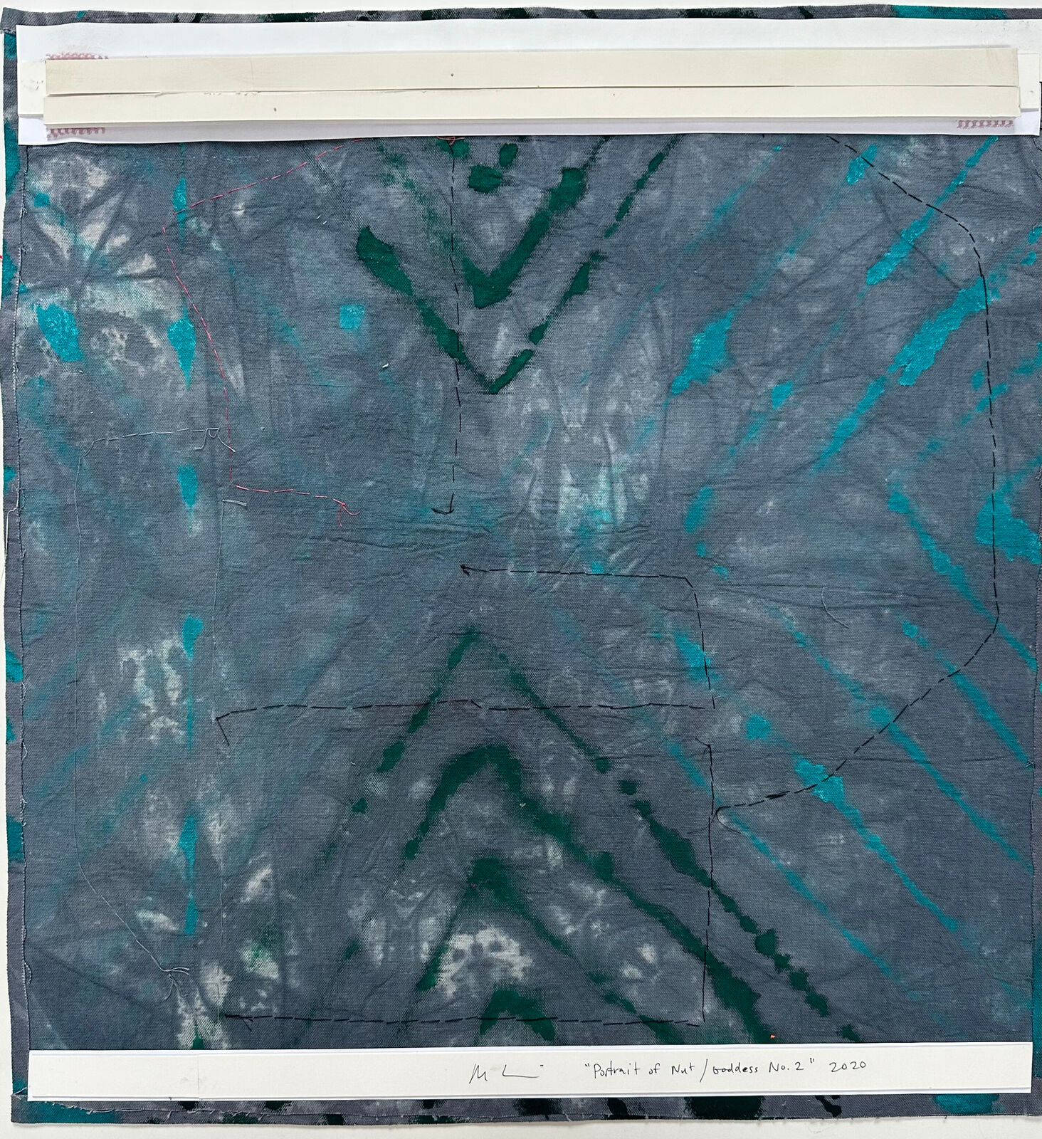 A textile collage featuring layered fabrics and abstract shapes.