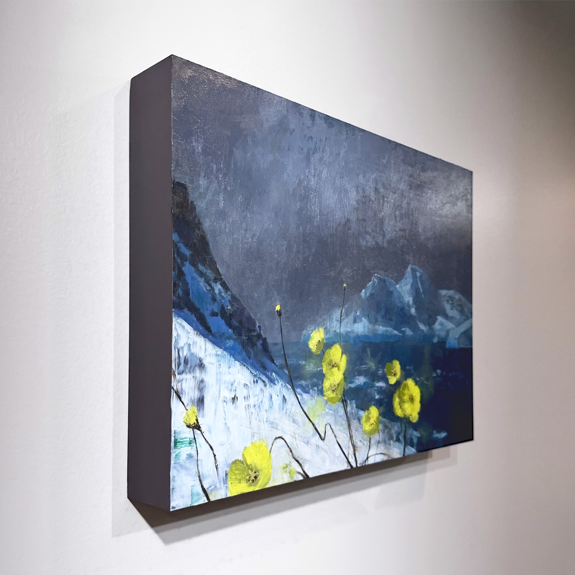 A dramatic landscape painting featuring bright yellow poppies against a dark, moody backdrop of snow-capped mountains.