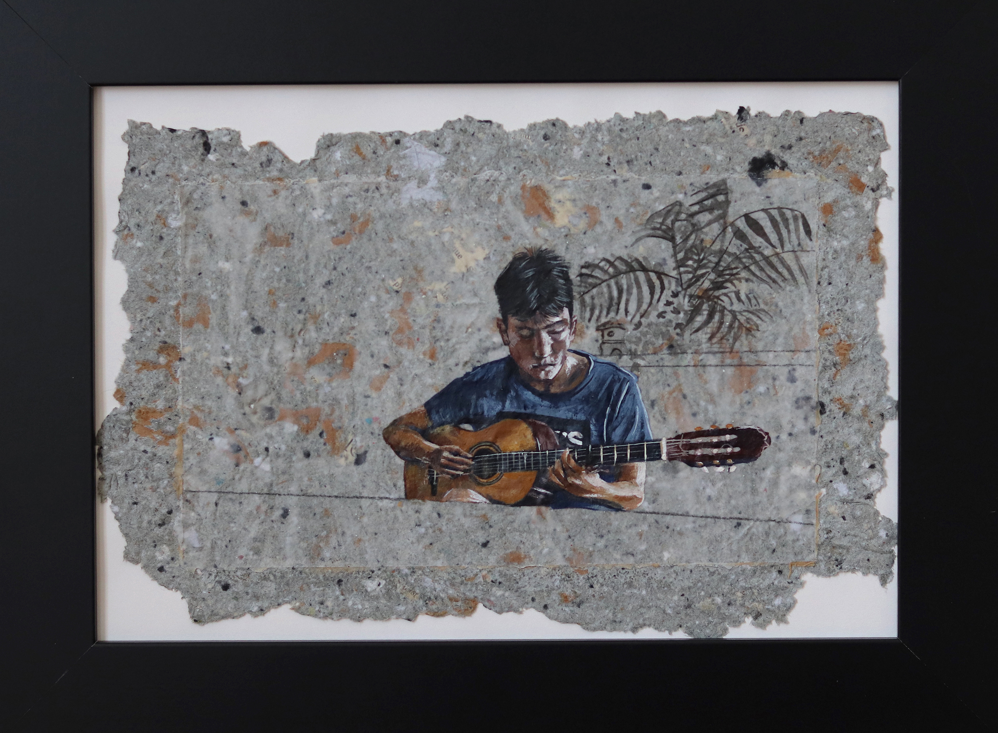 A painting of a man playing a guitar on a wall.