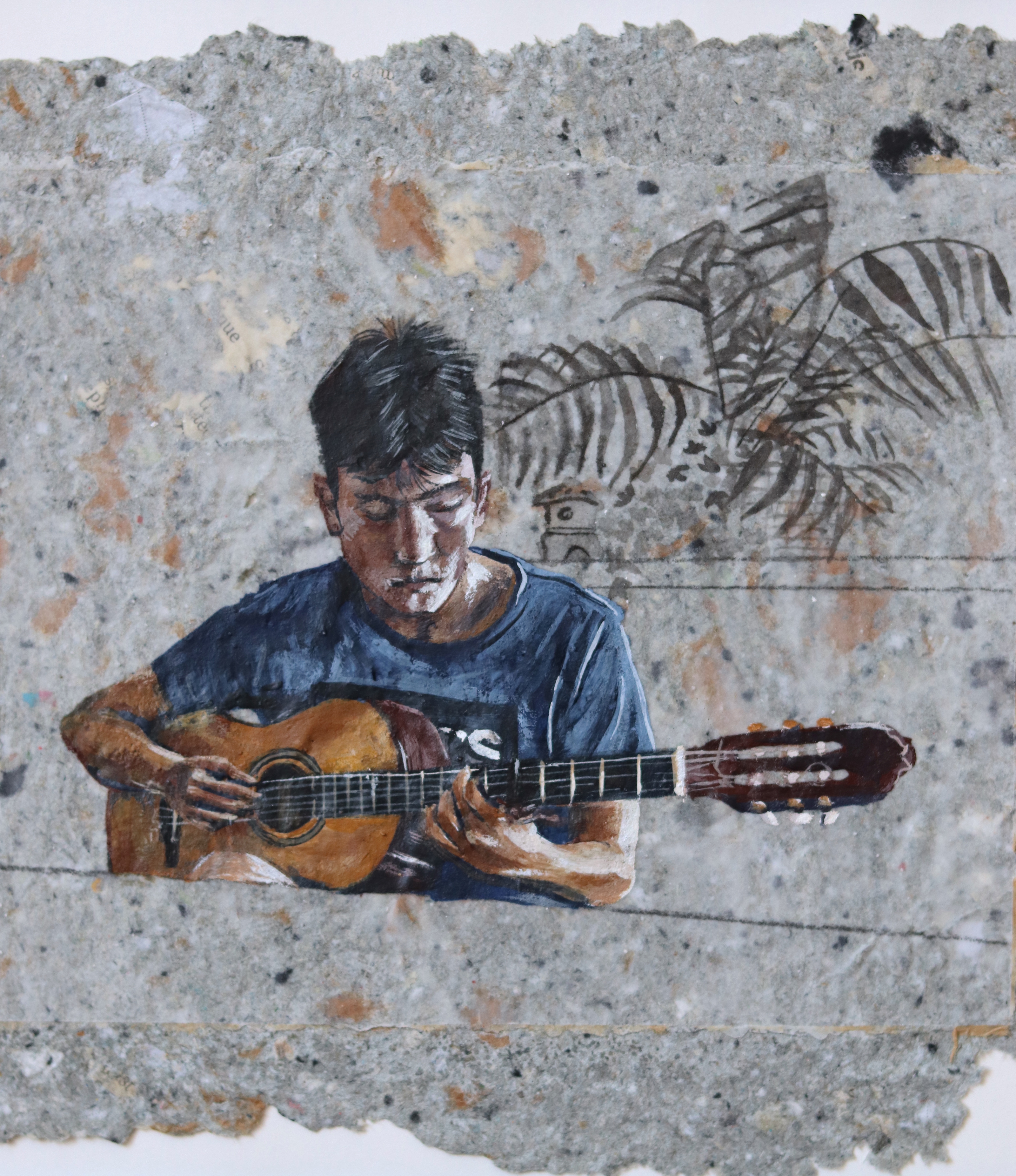 A painting of a man playing a guitar on a wall.